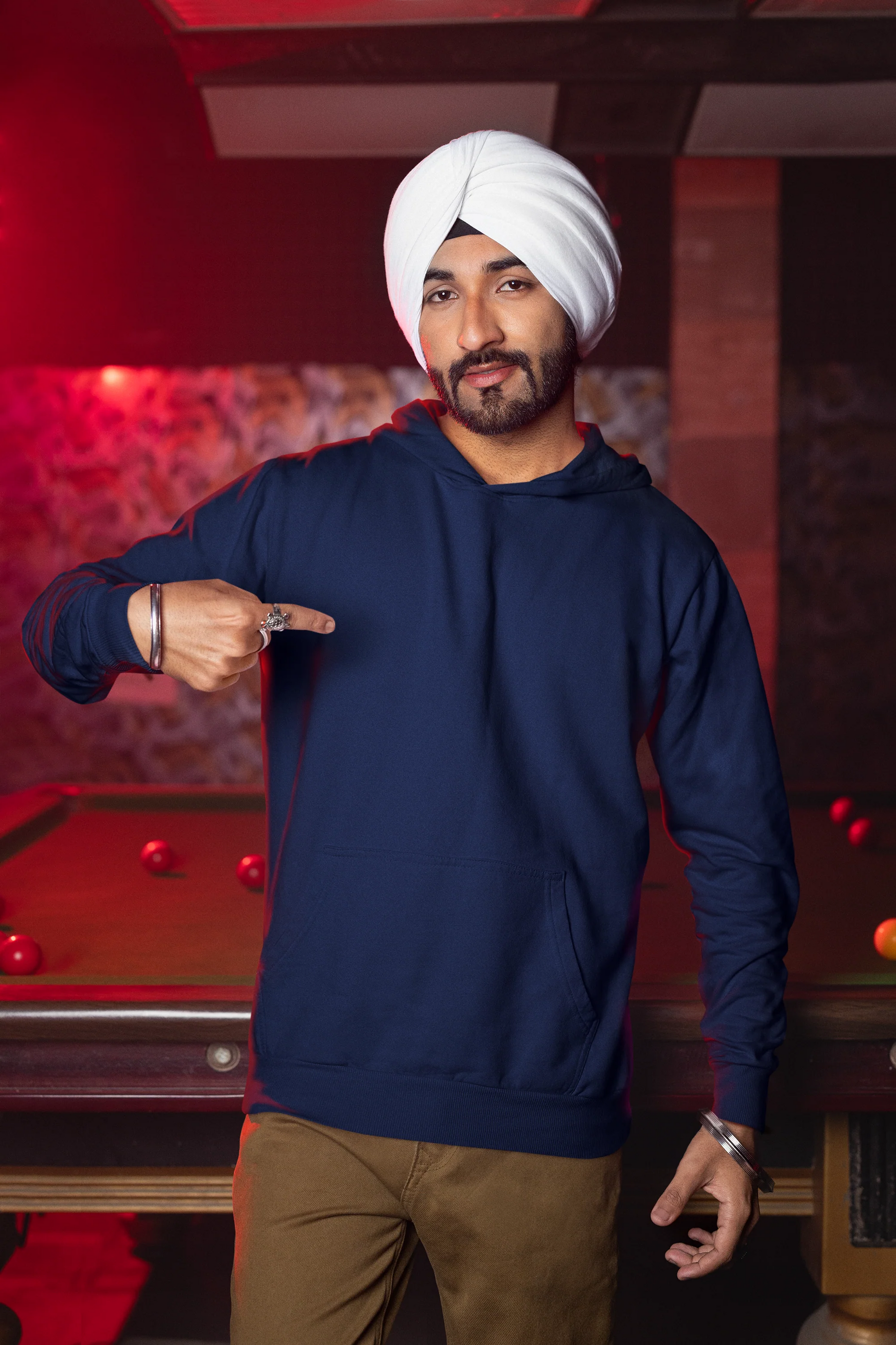 First front view of a male model wearing a royal blue hoodie with Diljit holding up a sunflower with the text "Dil Jeet" in the background.