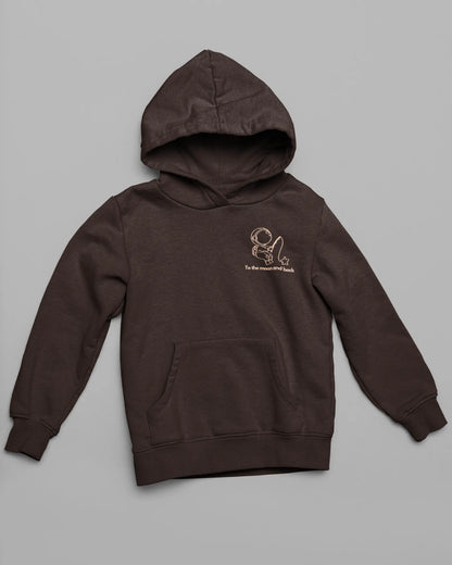 First front view of a matching chocolate brown hoodies, one with an astronaut design and the other with a planet design, along with the text "To the Moon and Back."