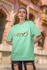 Second front view of a female model wearing an mint green oversized t-shirt with a colorful design that celebrates Marathi culture. Ideal for anyone who loves Maharashtra and its vibrant heritage.