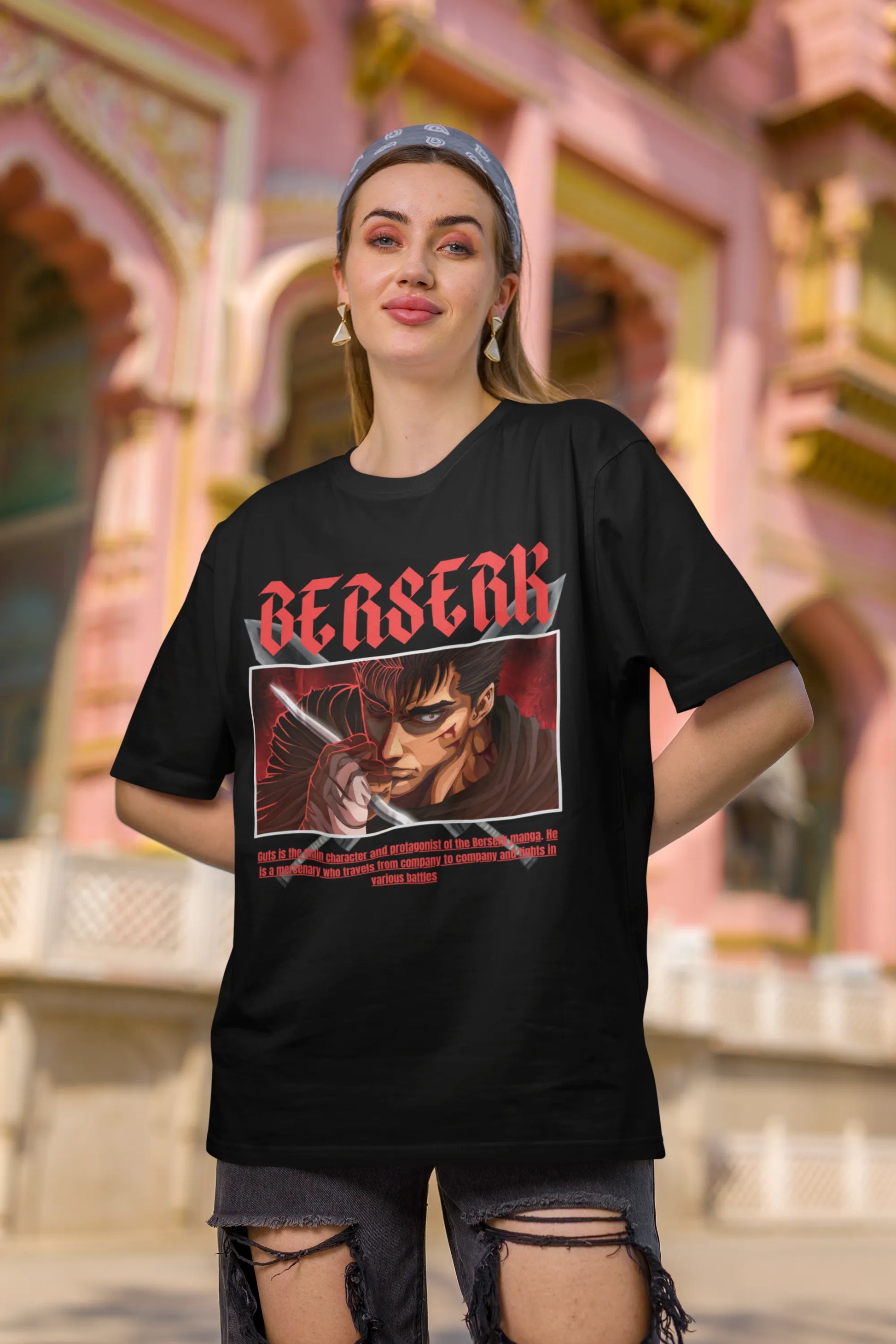 First front view of a female model wearing an black oversized t-shirt featuring Guts from the Berserk anime with the text "Berserk" across the design.