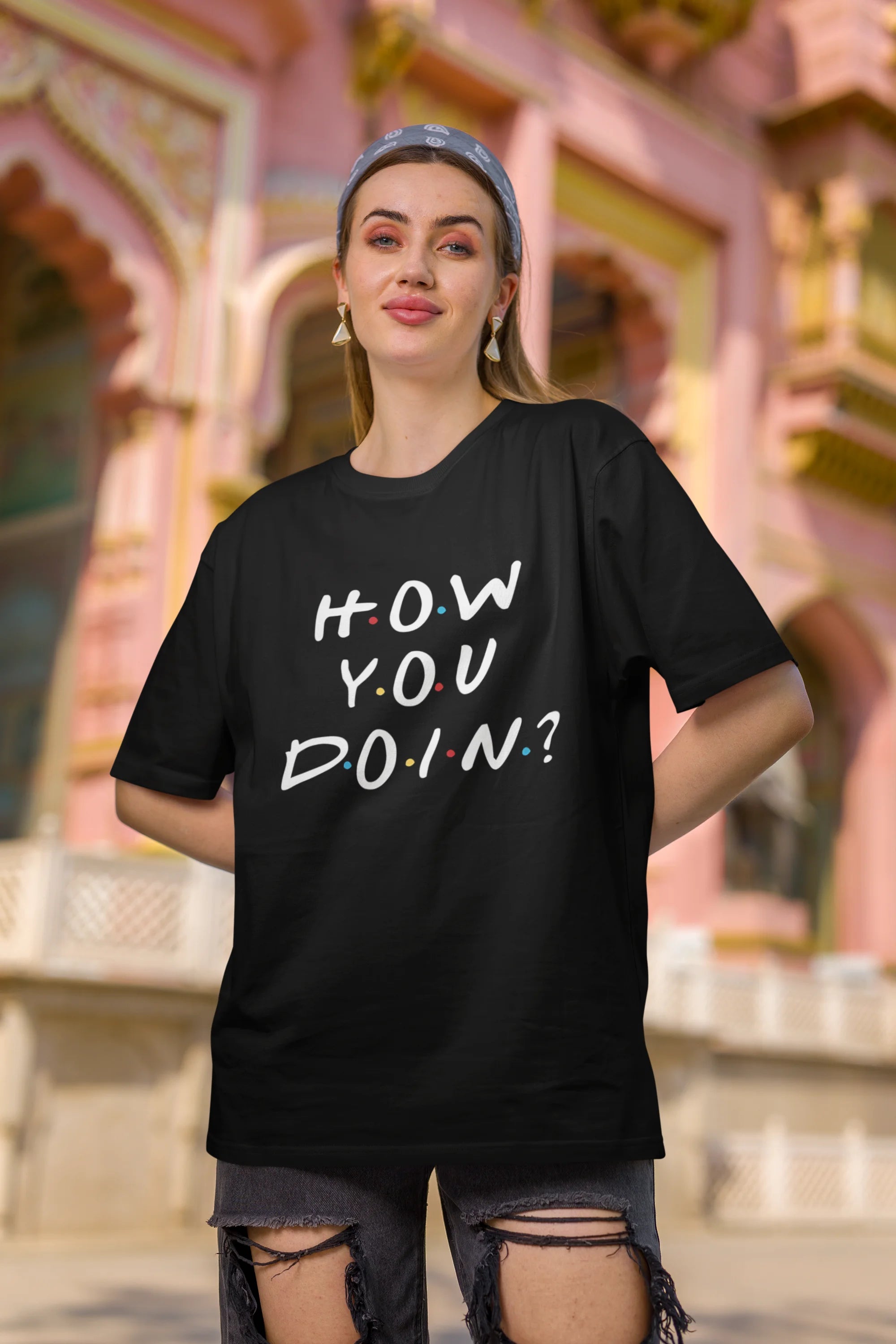 Second image of female model wearing black oversized t-shirt with F.R.I.E.N.D.S series inspired designs, embodying Joey's famous catchphrase 'How You Doin'?