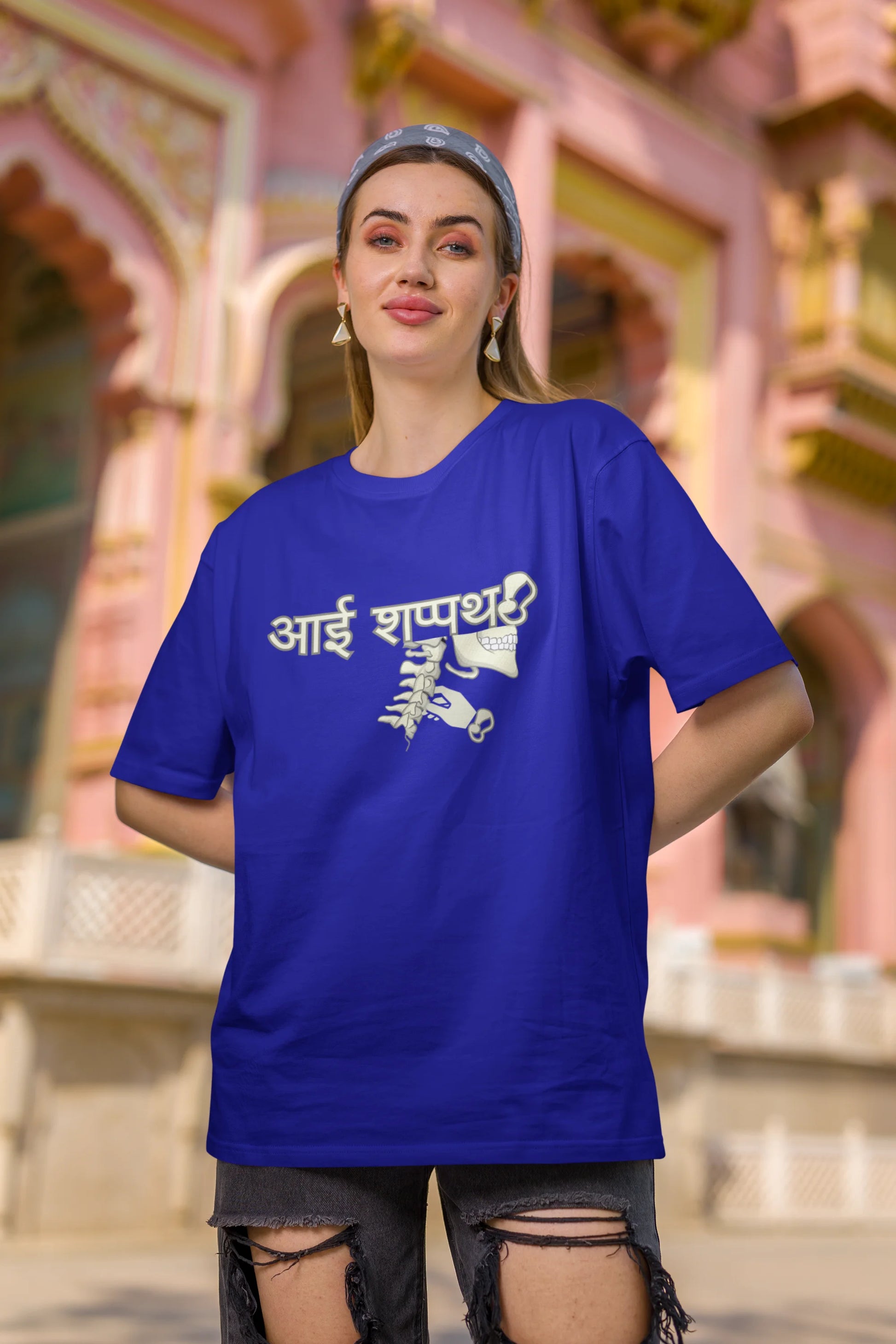 Third front view of female model wearing a royal blue oversized t-shirt featuring a design inspired by the Marathi saying "Aai Sapath." Perfect for fans of Marathi culture and anyone who wants to celebrate their heritage.