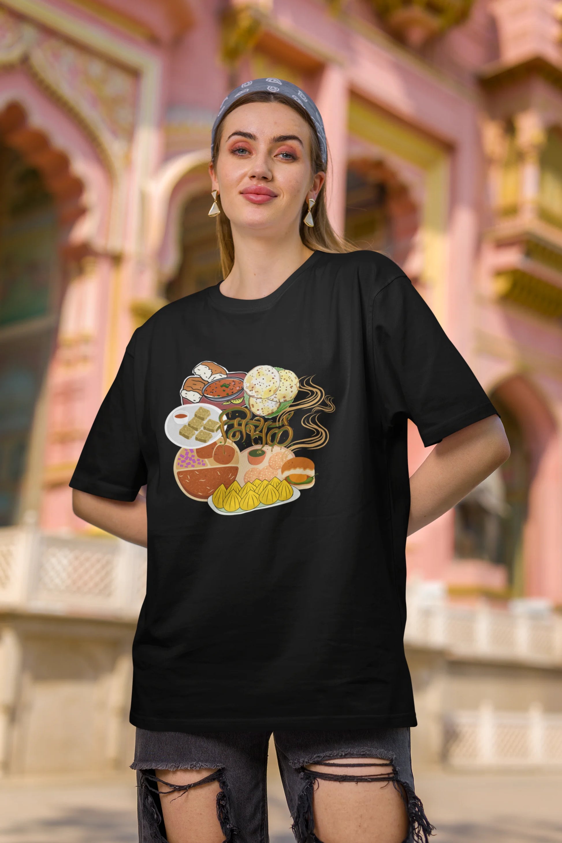 Second front view of female model wearing an black oversized t-shirt featuring a design inspired by the Marathi dish Misal Pav. Ideal for fans of Marathi culture, foodies, and anyone who loves a flavorful meal.