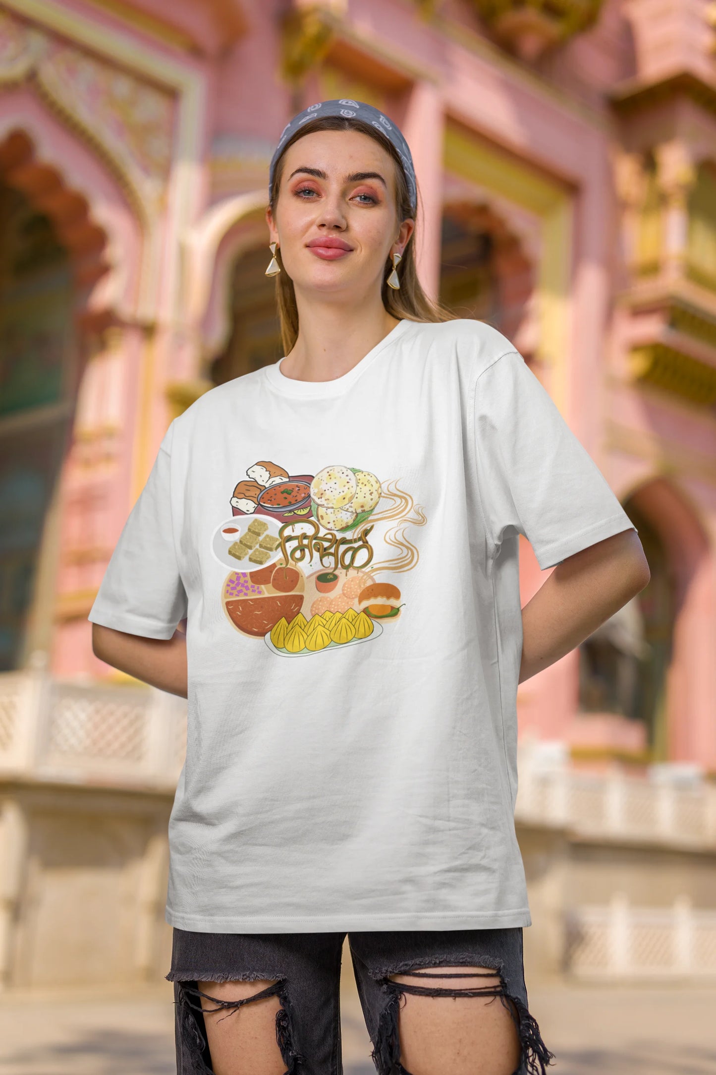 Second front view of female model wearing an off white oversized t-shirt featuring a design inspired by the Marathi dish Misal Pav. Ideal for fans of Marathi culture, foodies, and anyone who loves a flavorful meal.