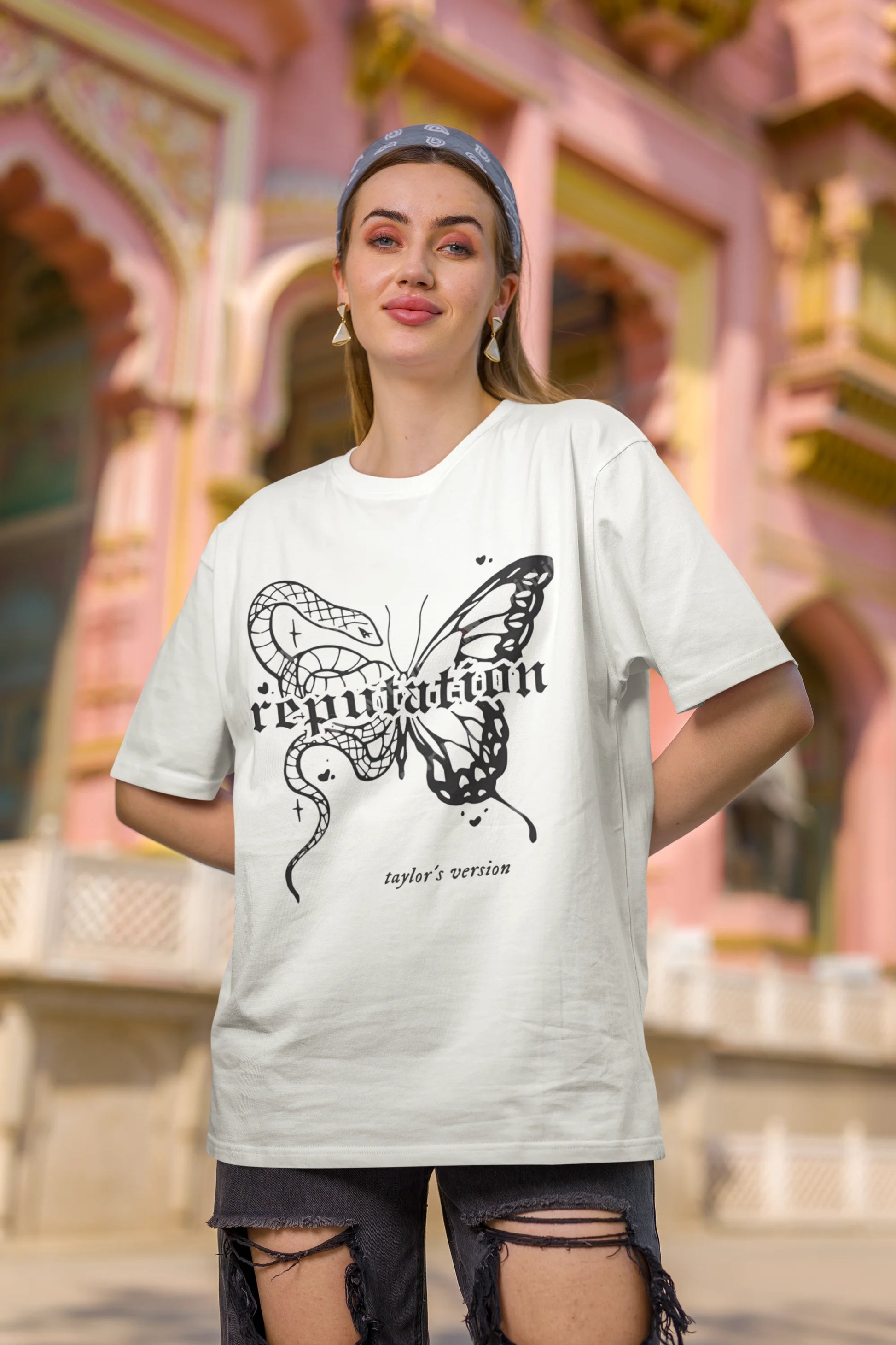 First Image of woman wearing white Oversize t-shirt featuring Reputation Taylor's Version design inspired by Taylor Swift's Reputation era