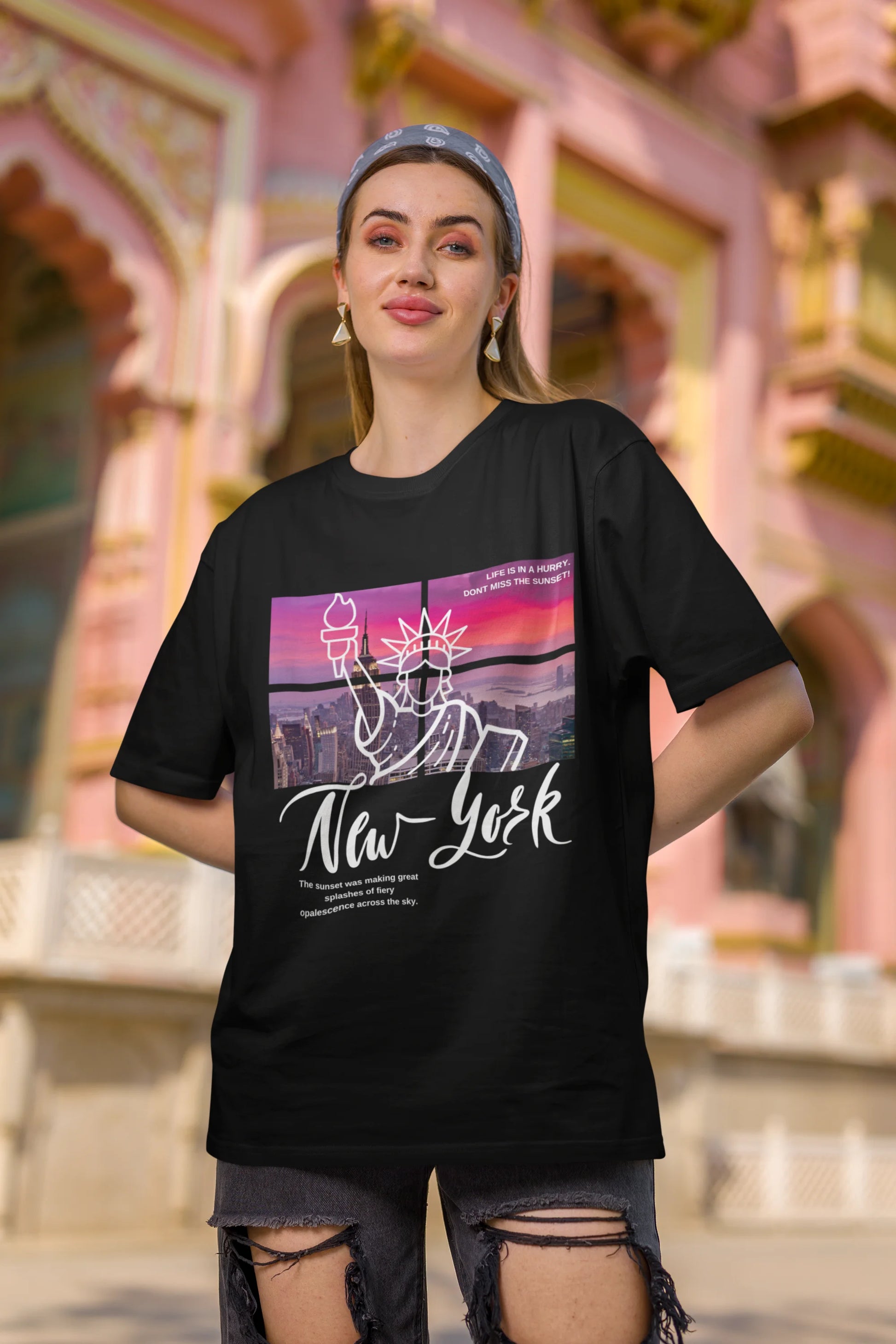 Second front view of a female model wearing a black oversized t-shirt with a New York City skyline design, offering a relaxed urban aesthetic.