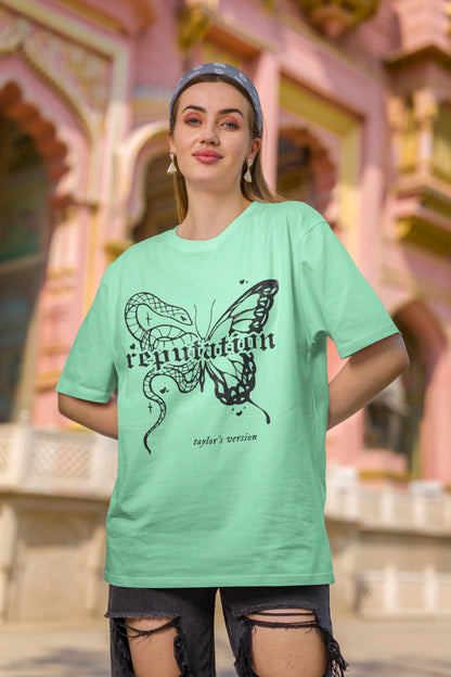 First Image of woman wearing mint green Oversize t-shirt featuring Reputation Taylor's Version design inspired by Taylor Swift's Reputation era