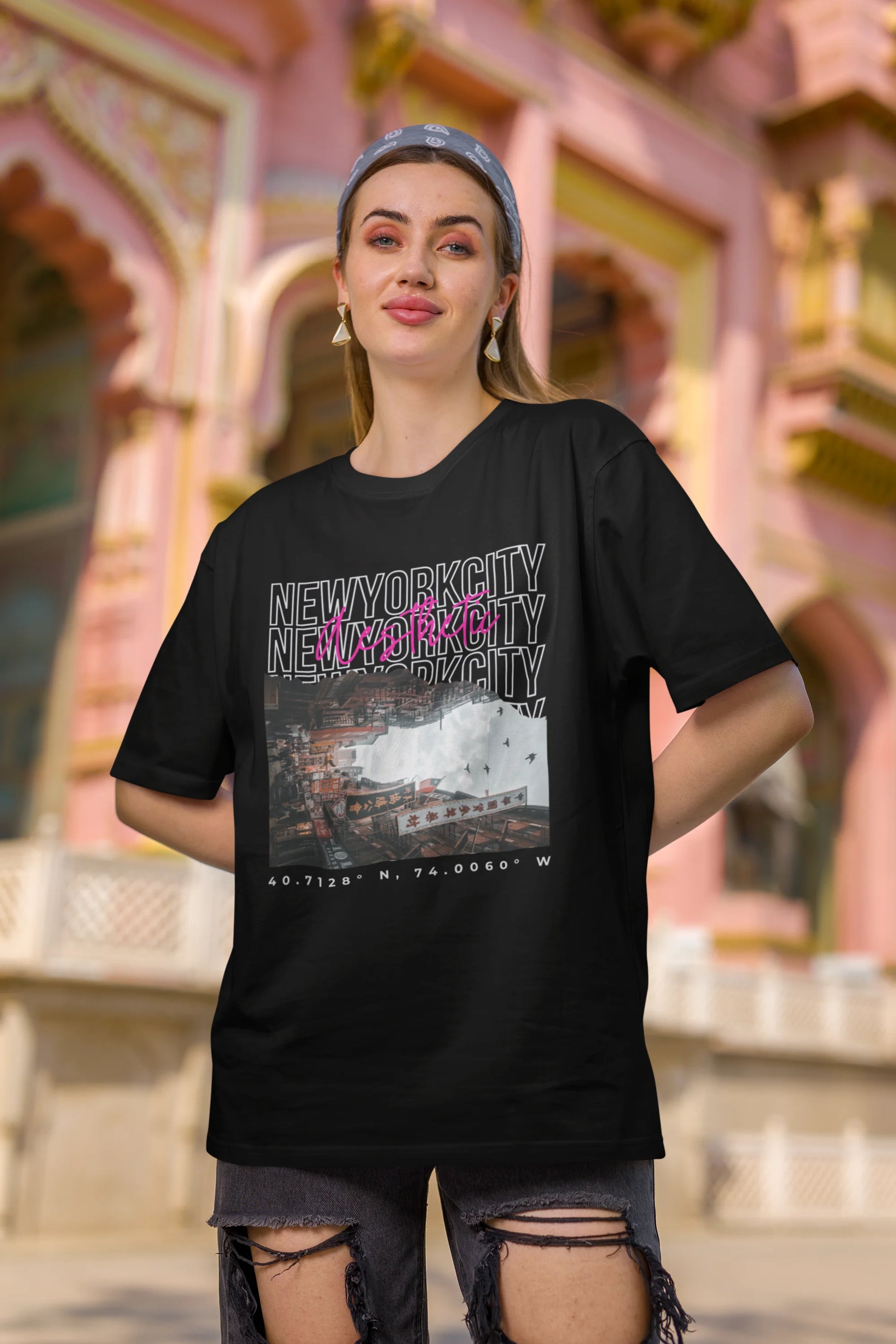 Third front view of a female model wearing an black oversized t-shirt with a New York City skyline design, offering a relaxed urban aesthetic.