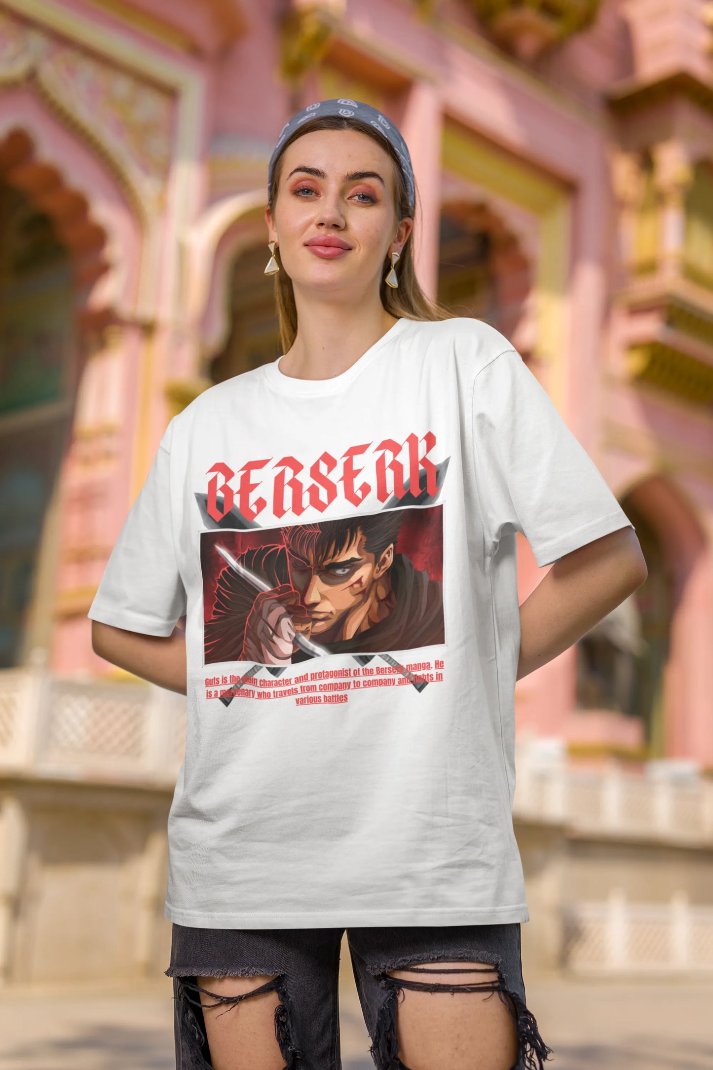 2nd front view of a female model wearing an off-white oversized t-shirt featuring Guts from the Berserk anime with the text "Berserk" across the design.