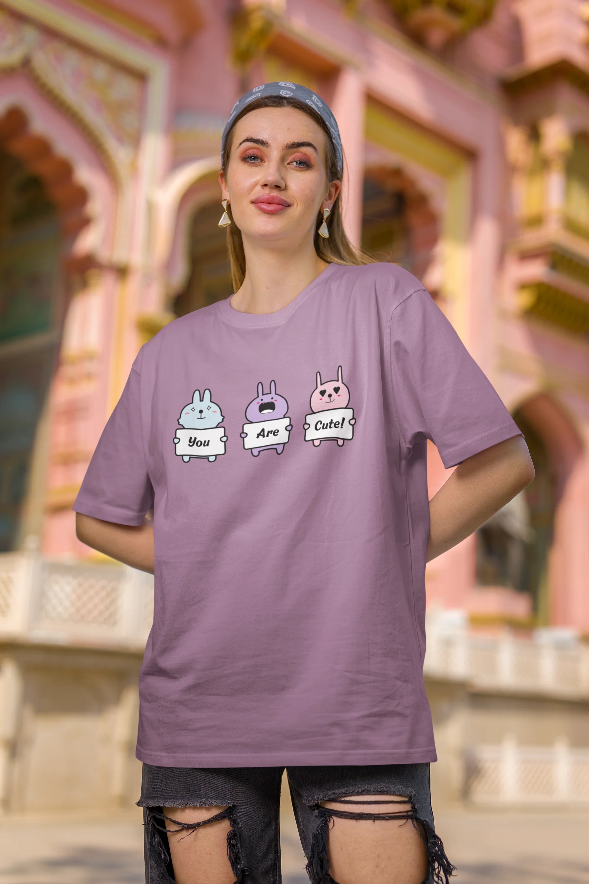 Second image of female model wearing Disney-themed dirty purple oversized tee with a cute cartoon design