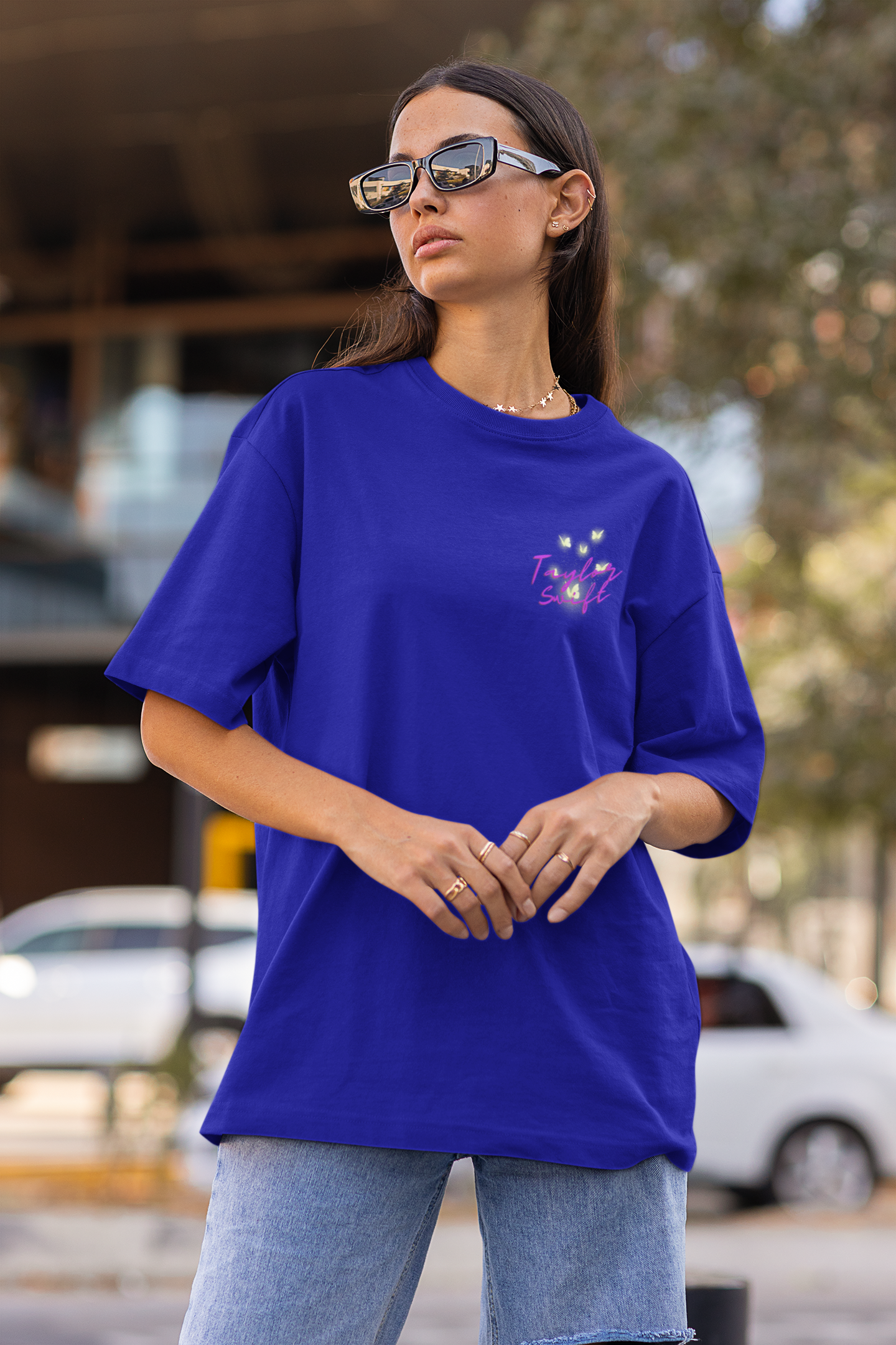 Side view of female model showcasing blue oversized Taylor Swift t-shirts inspired by her "Lover" album (Taylor's Version).