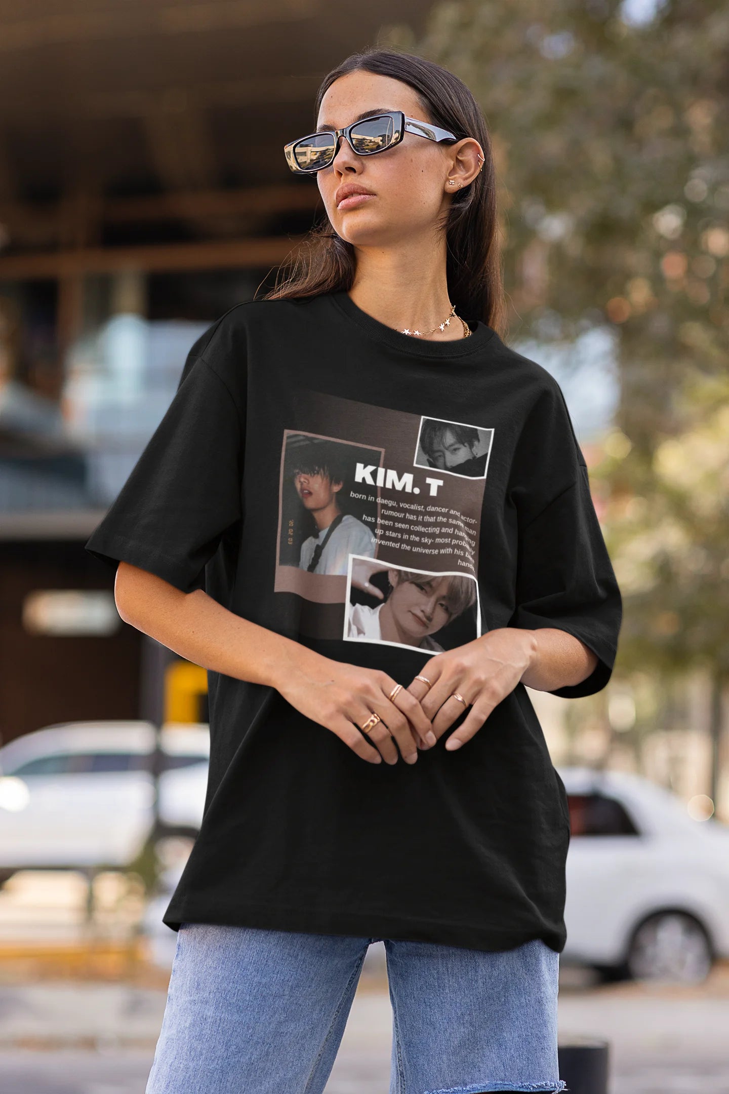 Side view of female model wearing a black oversized t-shirt featuring a bold design inspired by BTS member Kim Taehyung (V). Ideal for BTS fans (ARMY) and K-Pop enthusiasts.