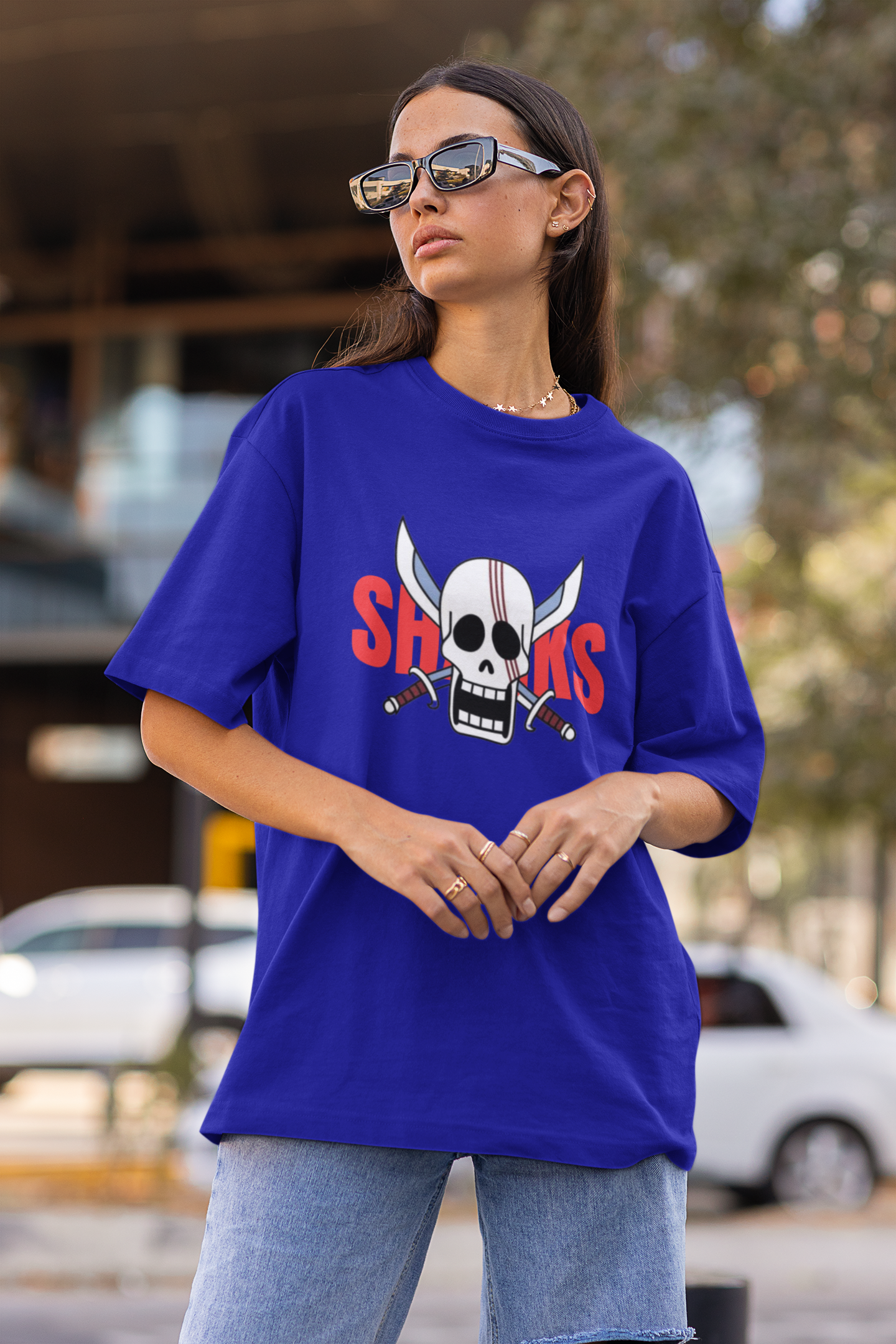 2nd front view of a female model wearing a royal blue oversized t-shirt featuring Red-Haired Shanks from the One Piece anime.