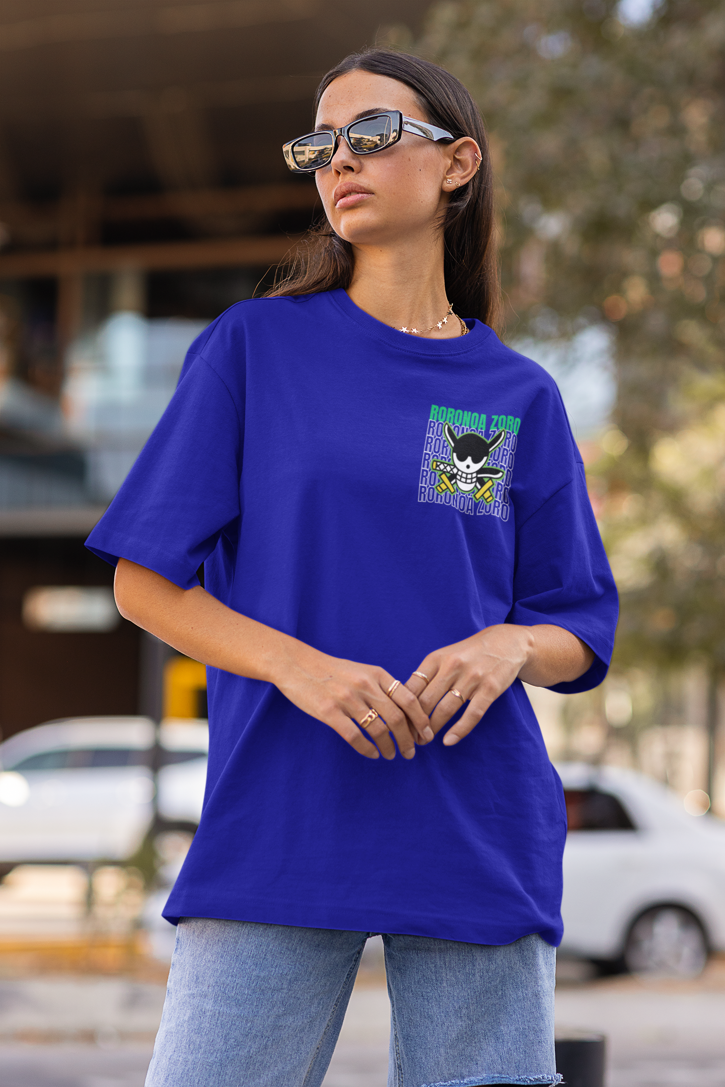 First front view of a female model wearing a royal blue oversized t-shirt featuring Roronoa Zoro from the One Piece anime.