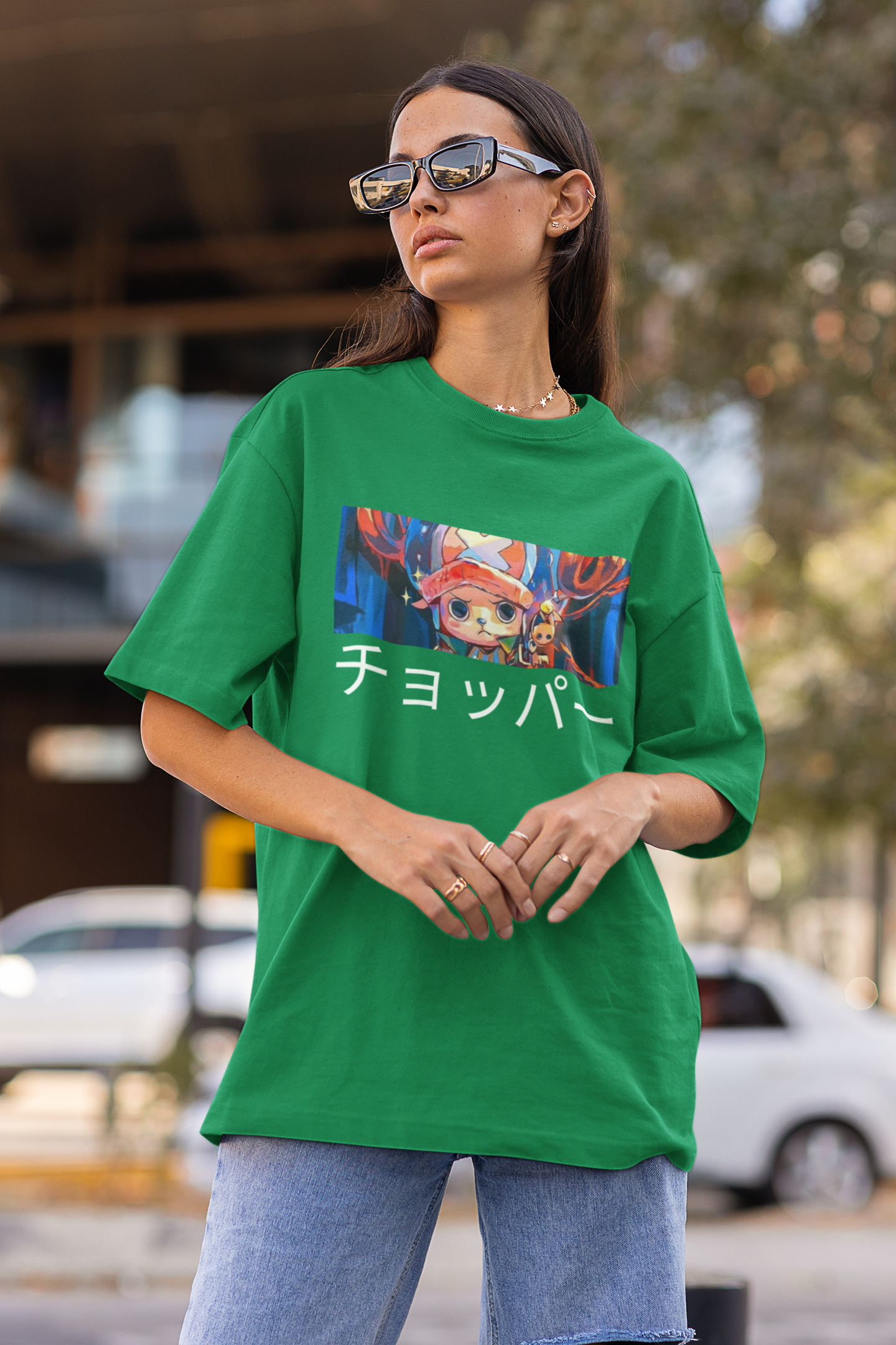 First front view a female model wearing a forest green oversized t-shirt featuring Tony Chopper from the One Piece anime.