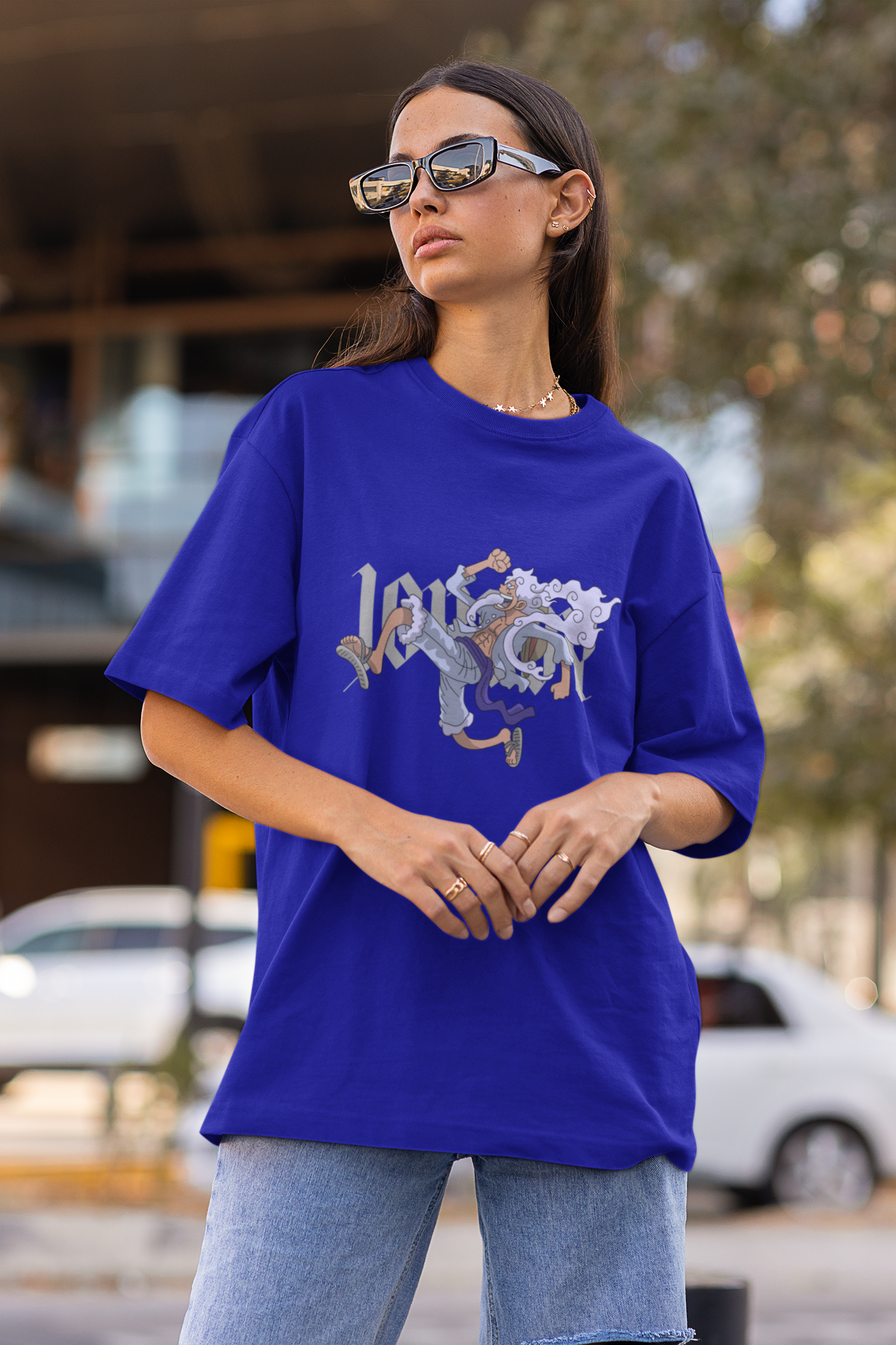 3rd front view of a female model wearing a royal blue oversized t-shirt featuring Luffy in his Gear 5 form from the One Piece anime.