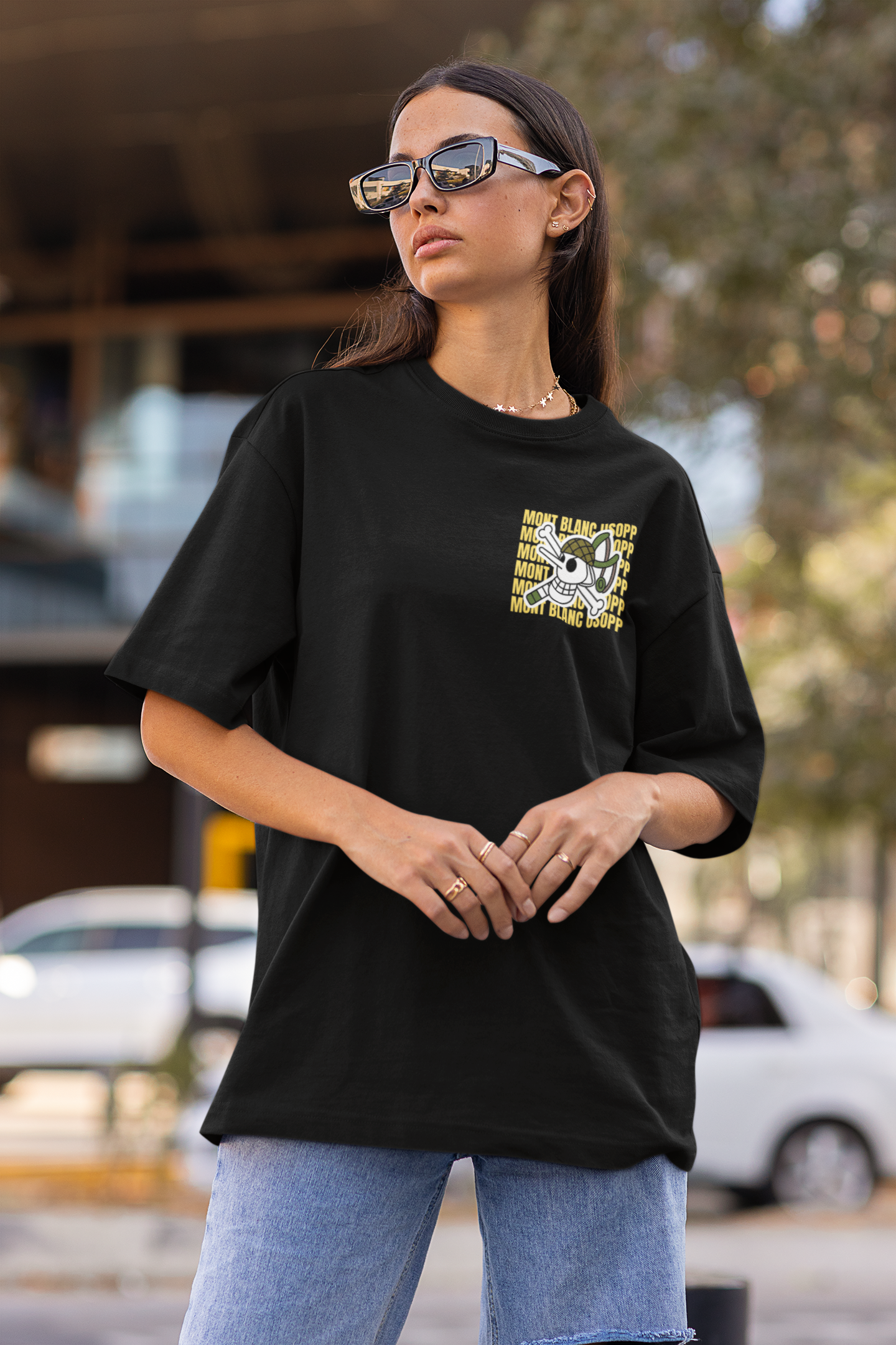 2nd front view of a female model wearing a black oversized t-shirt featuring Usopp from the One Piece anime.