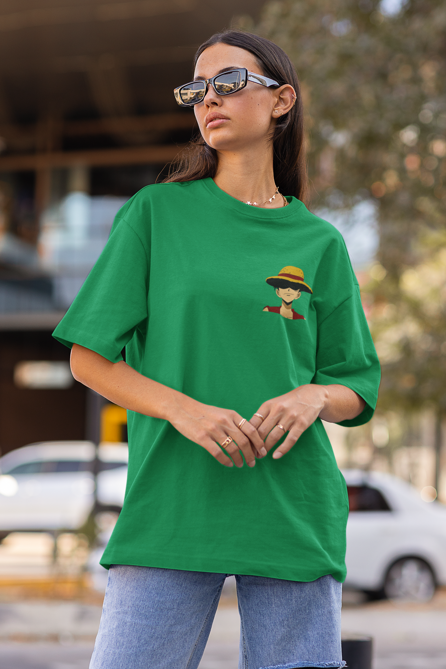 Front view of a female model wearing a forest green oversized t-shirt featuring Monkey D. Luffy from the One Piece anime.