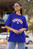 Side view of female model wearing an royal blue oversized t-shirt with the hilarious message 