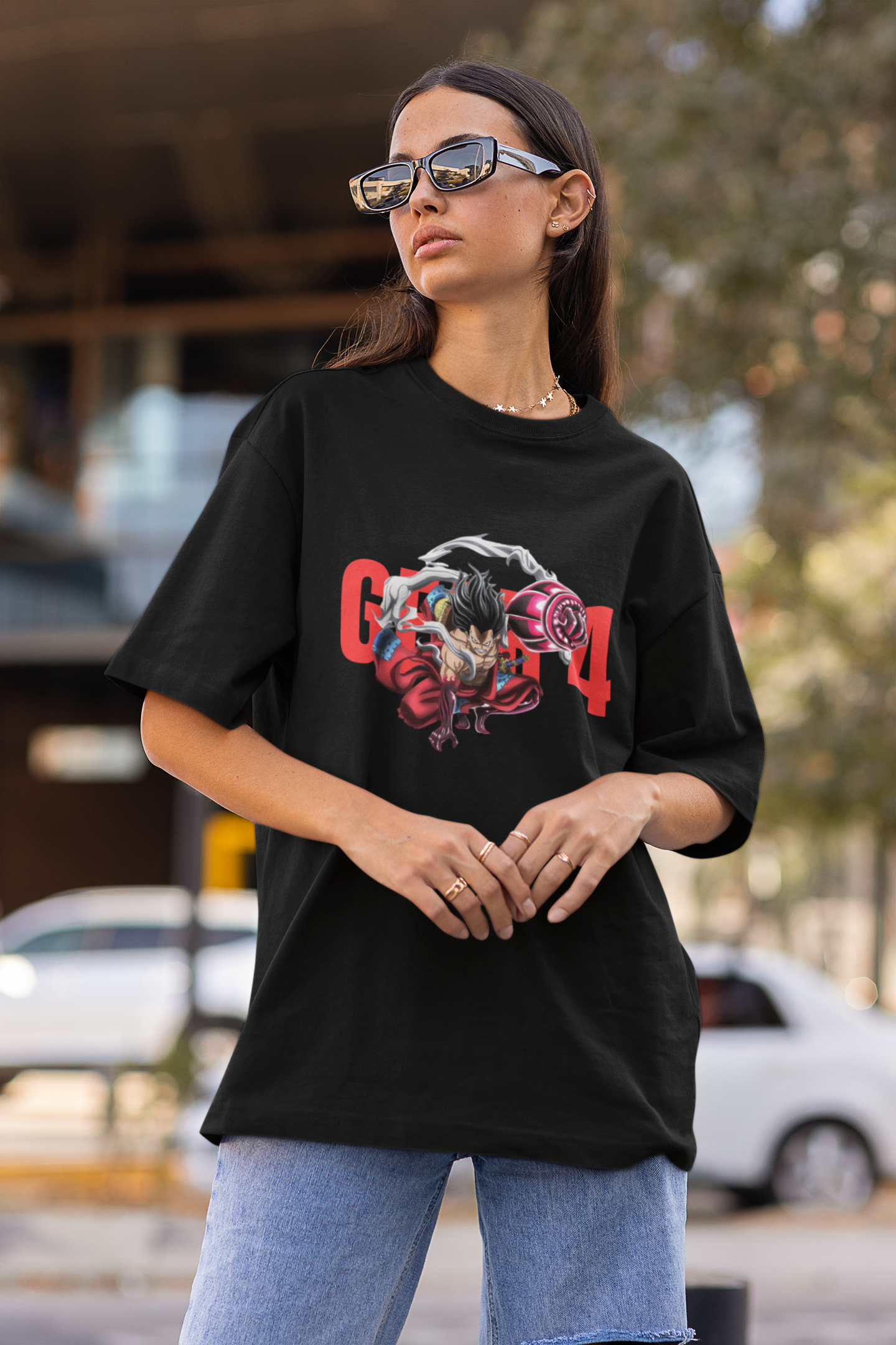 2nd front view of a female model wearing a black oversized t-shirt featuring Luffy in his Gear 4 Bounceman form from the One Piece anime.
