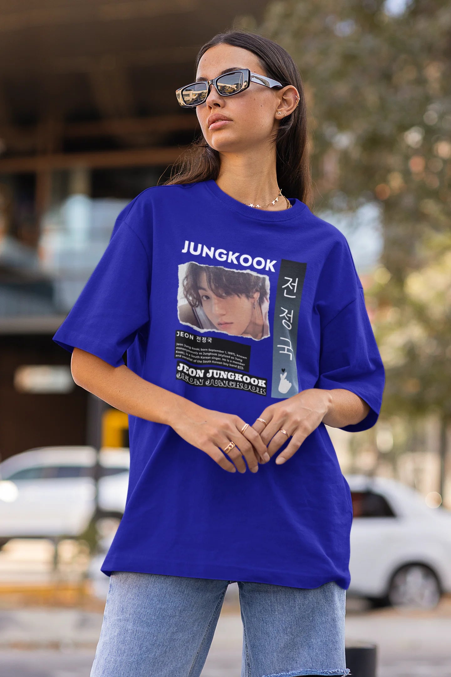 Side view of a female model wearing a royal blue oversized t-shirt featuring a vibrant design inspired by BTS member Jungkook. Ideal for fans of BTS and K-Pop music in general.