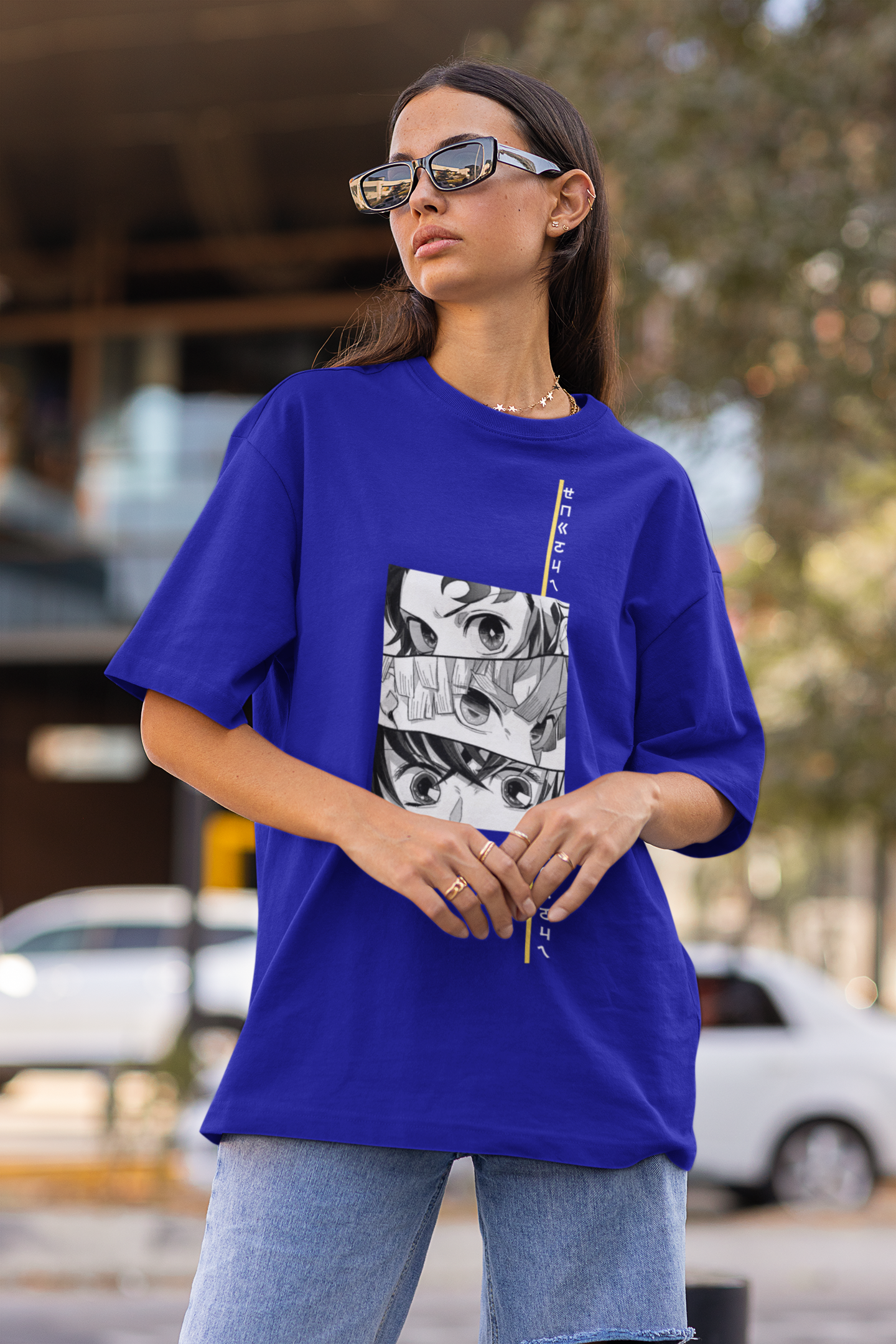 Front view of a female model wearing a royal blue oversized t-shirt featuring Tanjiro Kamado from Demon Slayer: Kimetsu no Yaiba.