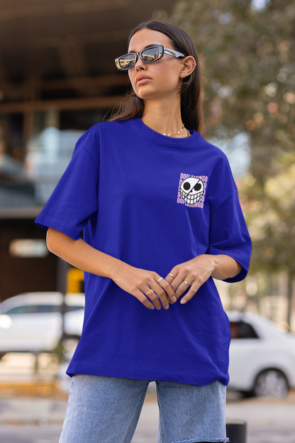 3rd front view of a female model wearing a royal blue oversized t-shirt featuring Donquixote Doflamingo from the One Piece anime.