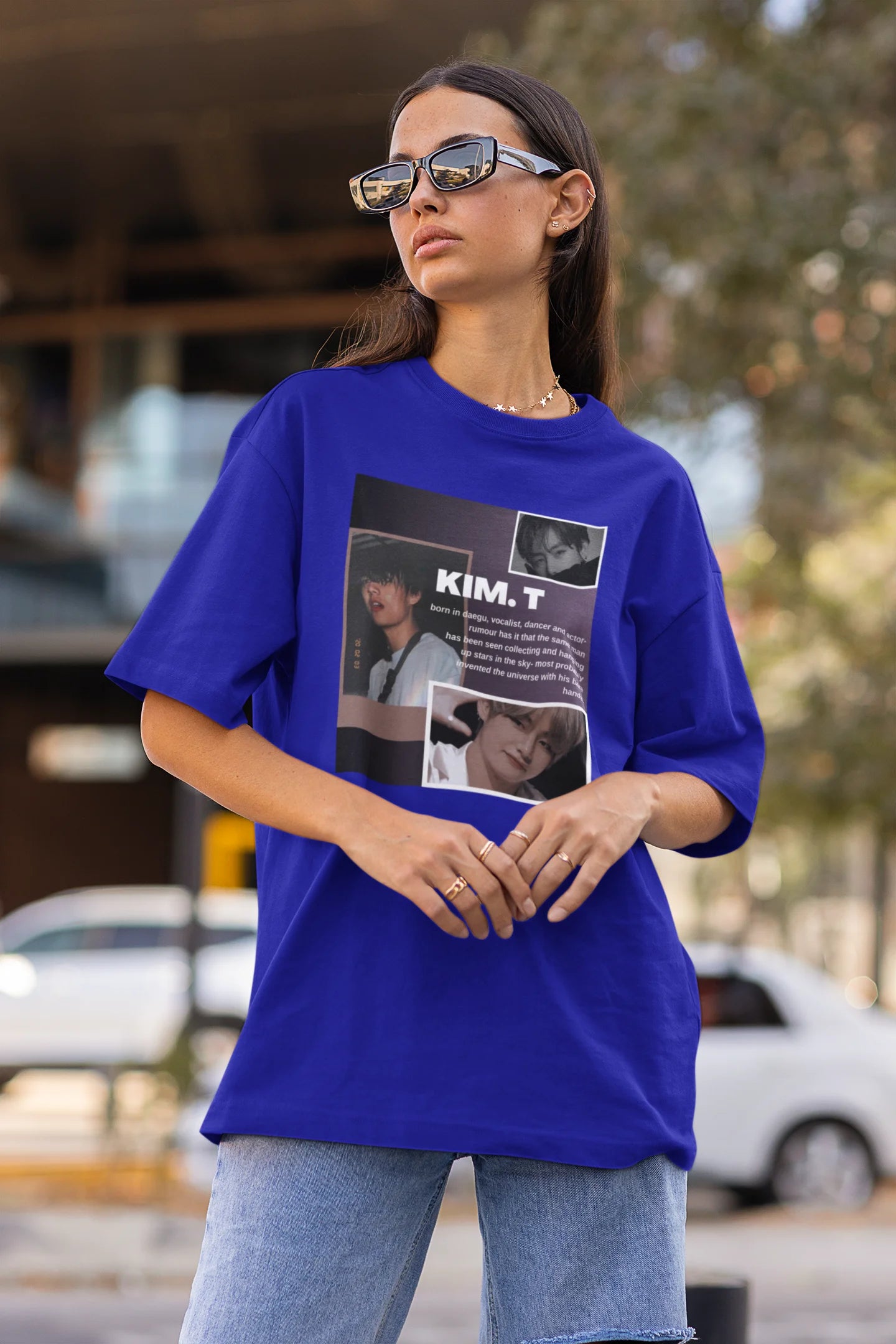 Side view of female model wearing a royal blue oversized t-shirt featuring a bold design inspired by BTS member Kim Taehyung (V). Ideal for BTS fans (ARMY) and K-Pop enthusiasts.