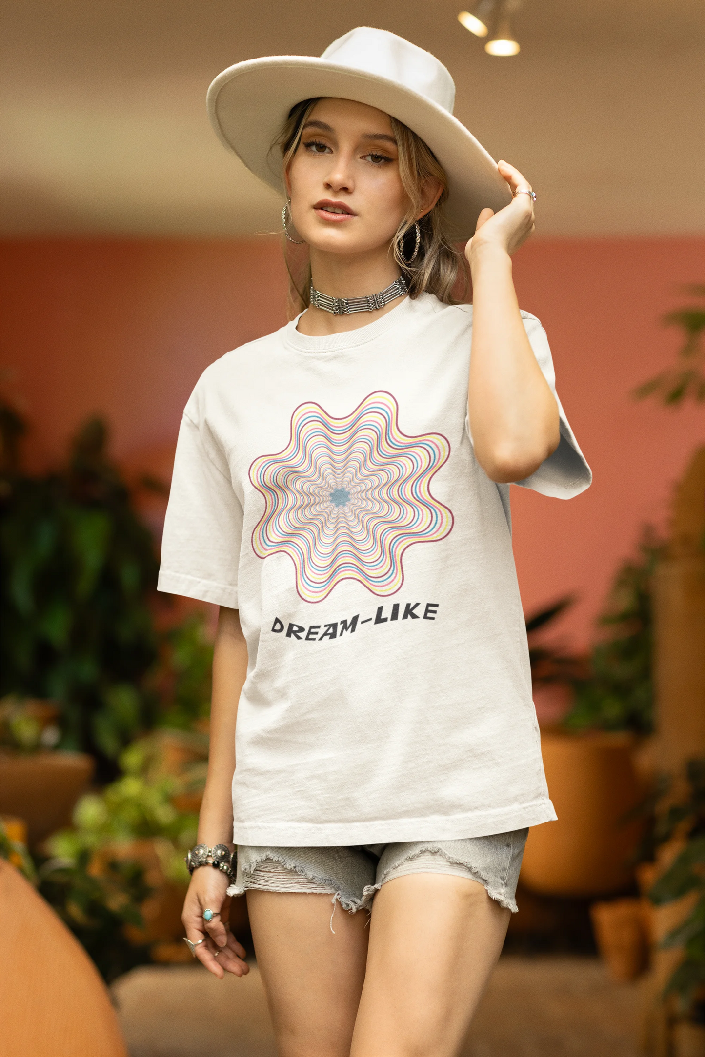 Side view of a female model wearing an off-white Oversized t-shirt with a dreamlike spiderweb design made of frequencies, offering a visually captivating and relaxing aesthetic.