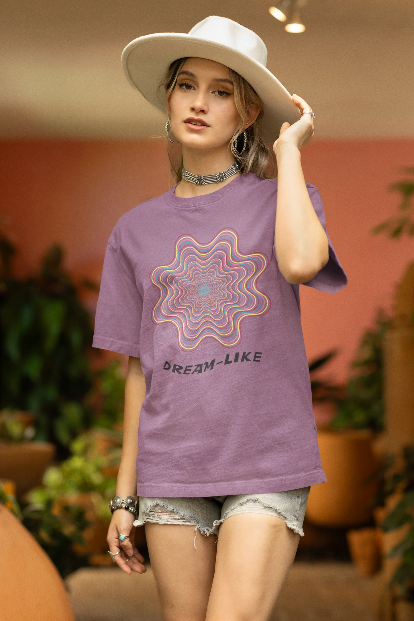 Side view of a female model wearing an dirty purple oversized t-shirt with a dreamlike spiderweb design made of frequencies, offering a visually captivating and relaxing aesthetic.
