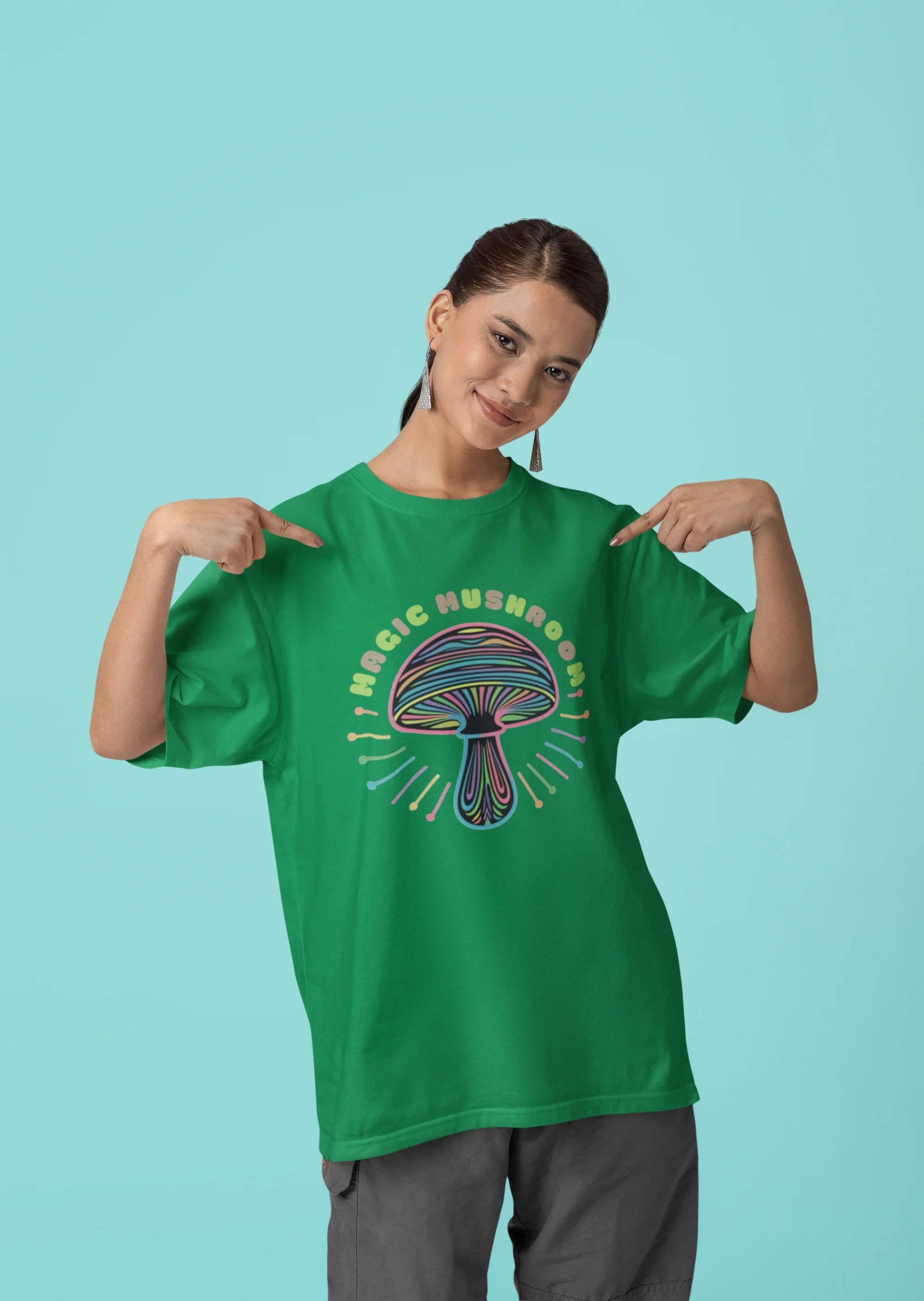 Third front view of a female model wearing a forest green oversized t-shirt featuring a psychedelic magic mushroom with an aura, perfect for a hippie, trance, or groovy style.