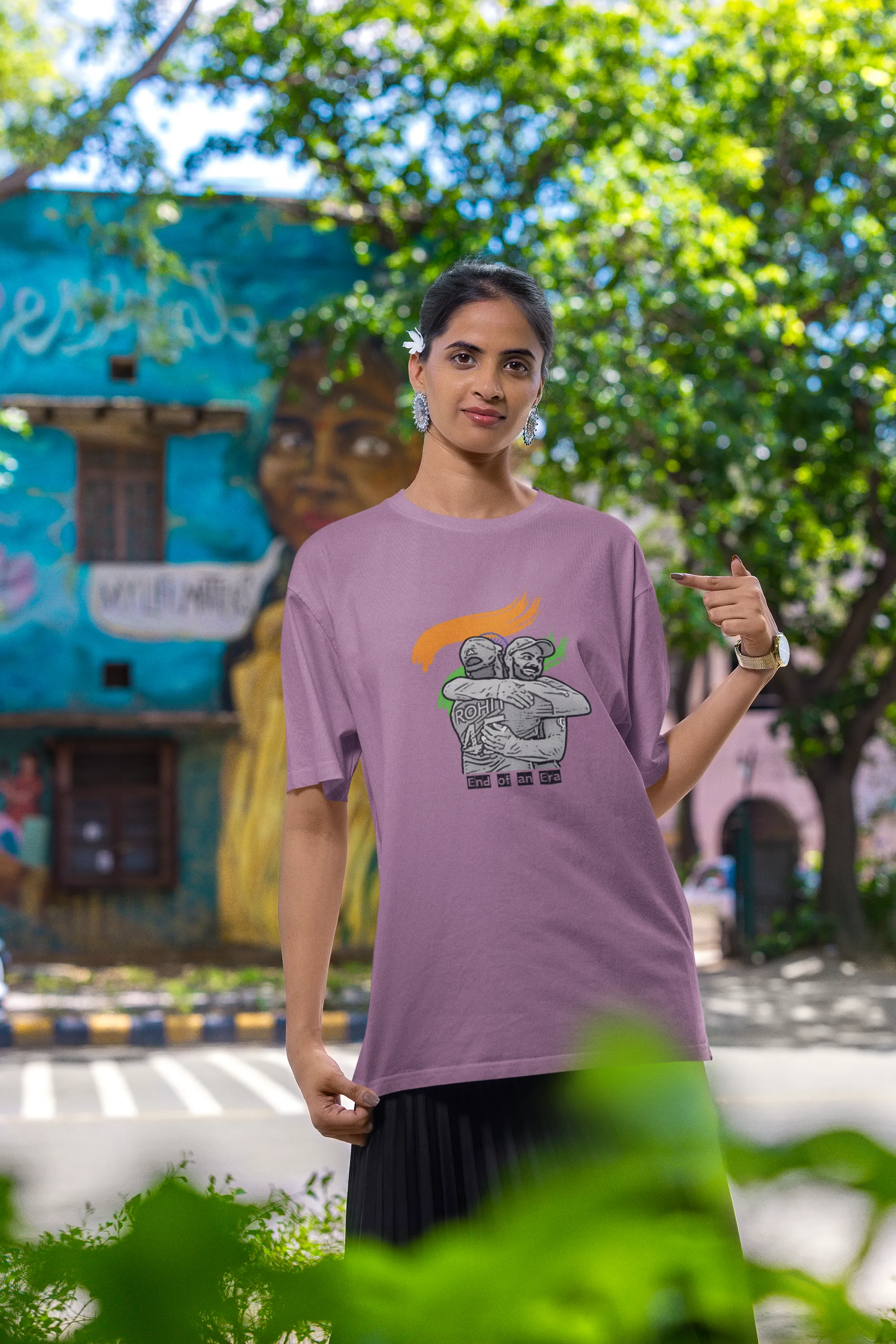 Third front view of a female model wearing a dirty purple oversized t-shirt featuring a photo of Virat Kohli and Rohit Sharma in a celebratory hug after the World Cup 2024 final. Ideal for Indian cricket fans who want to honor the team's victory and potentially a changing of the guard.