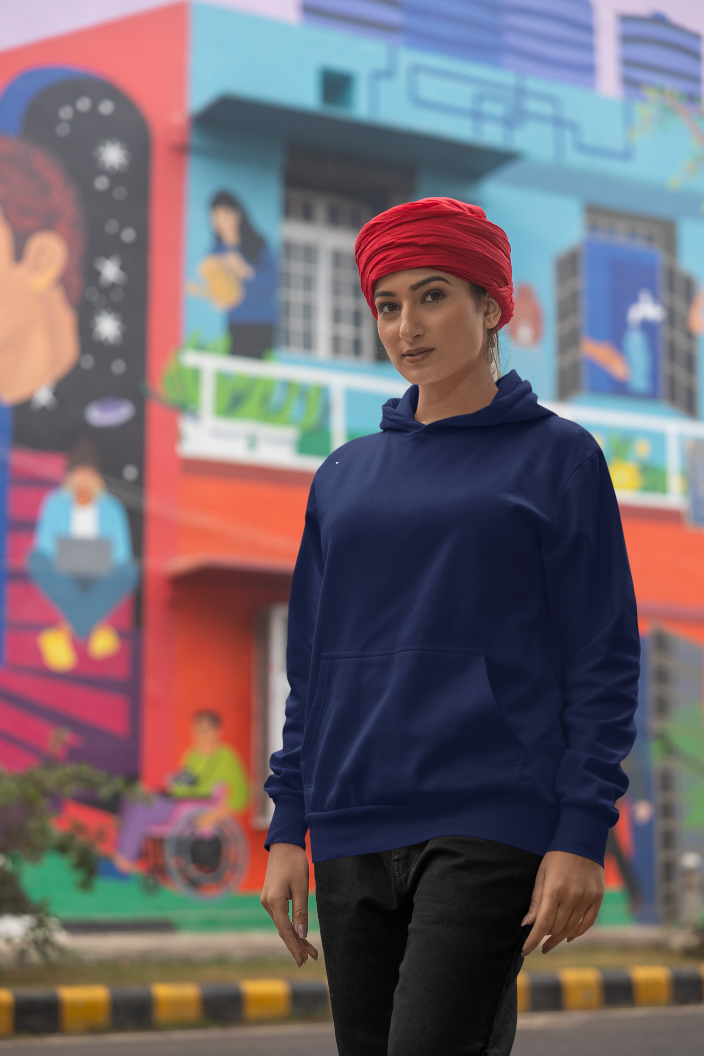 Second front view of a female model wearing a royal blue hoodie with Diljit holding up a sunflower with the text "Dil Jeet" in the background.