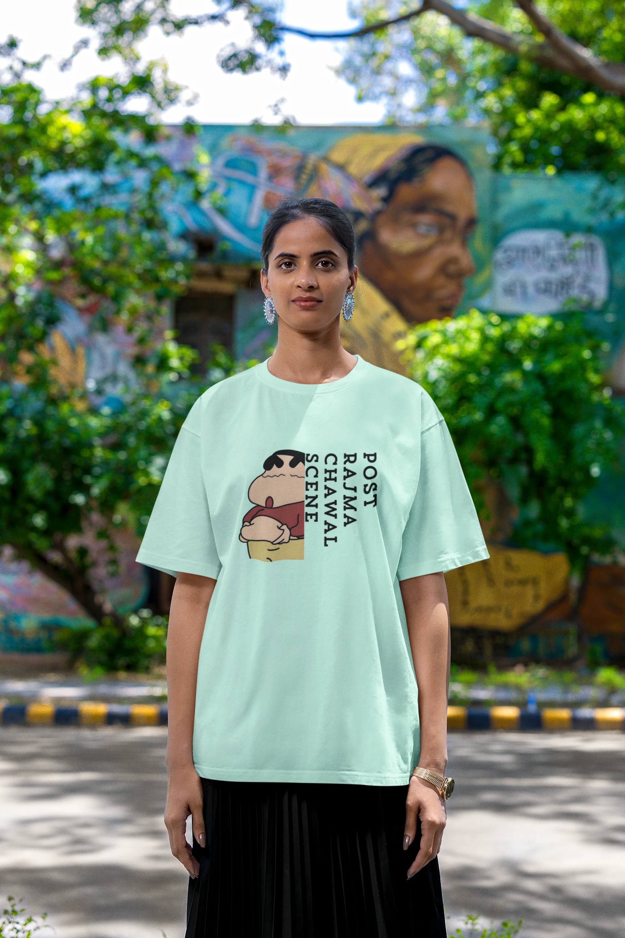 Second front image of a female model wearing an oversized mint green tee with a humorous design of Shinchan enjoying a food coma. A must-have for Shinchan fans and food lovers.