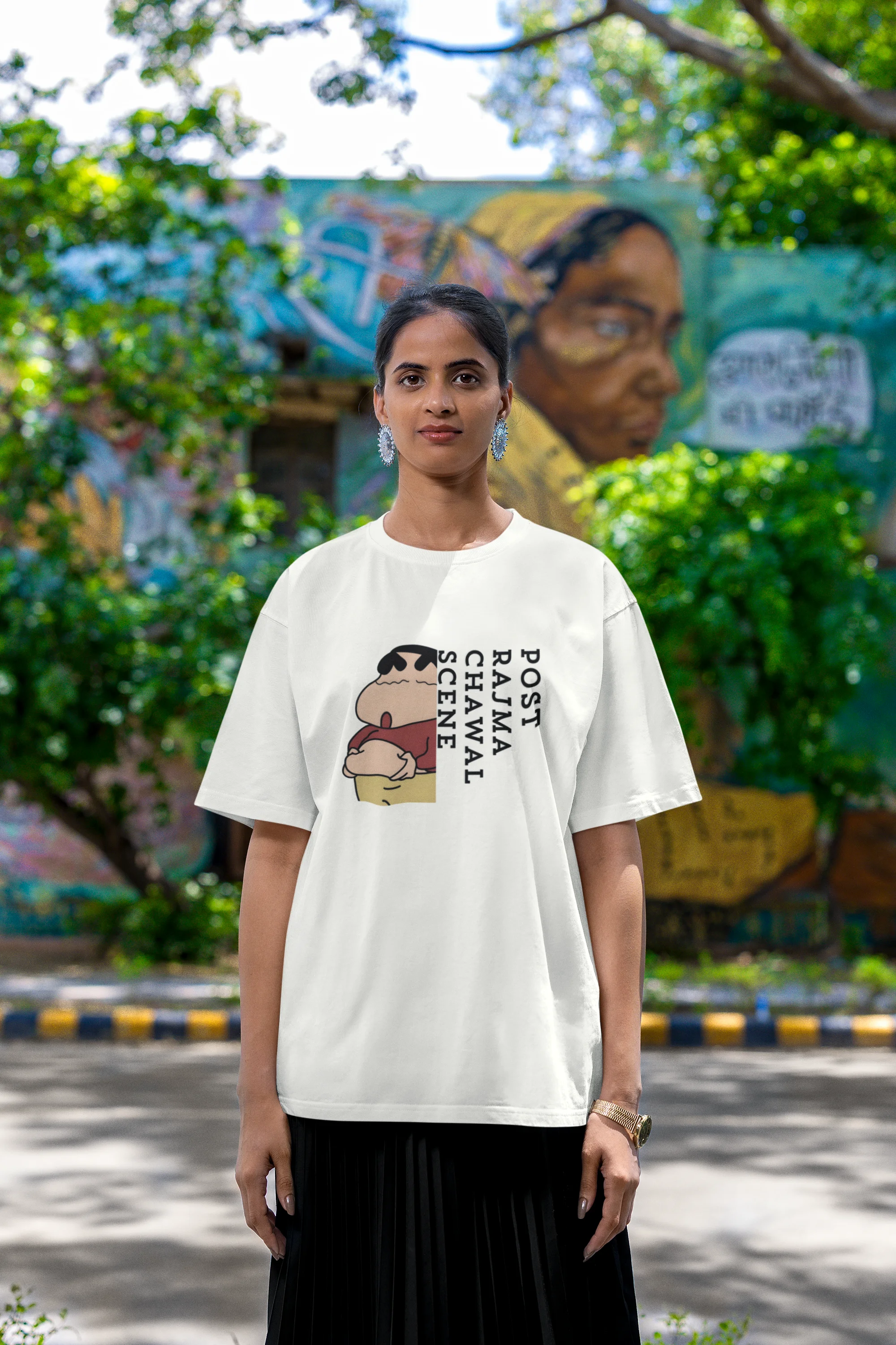 Second front image of female model wearing an oversized off-white tee with a humorous design of Shinchan enjoying a food coma. A must-have for Shinchan fans and food lovers.