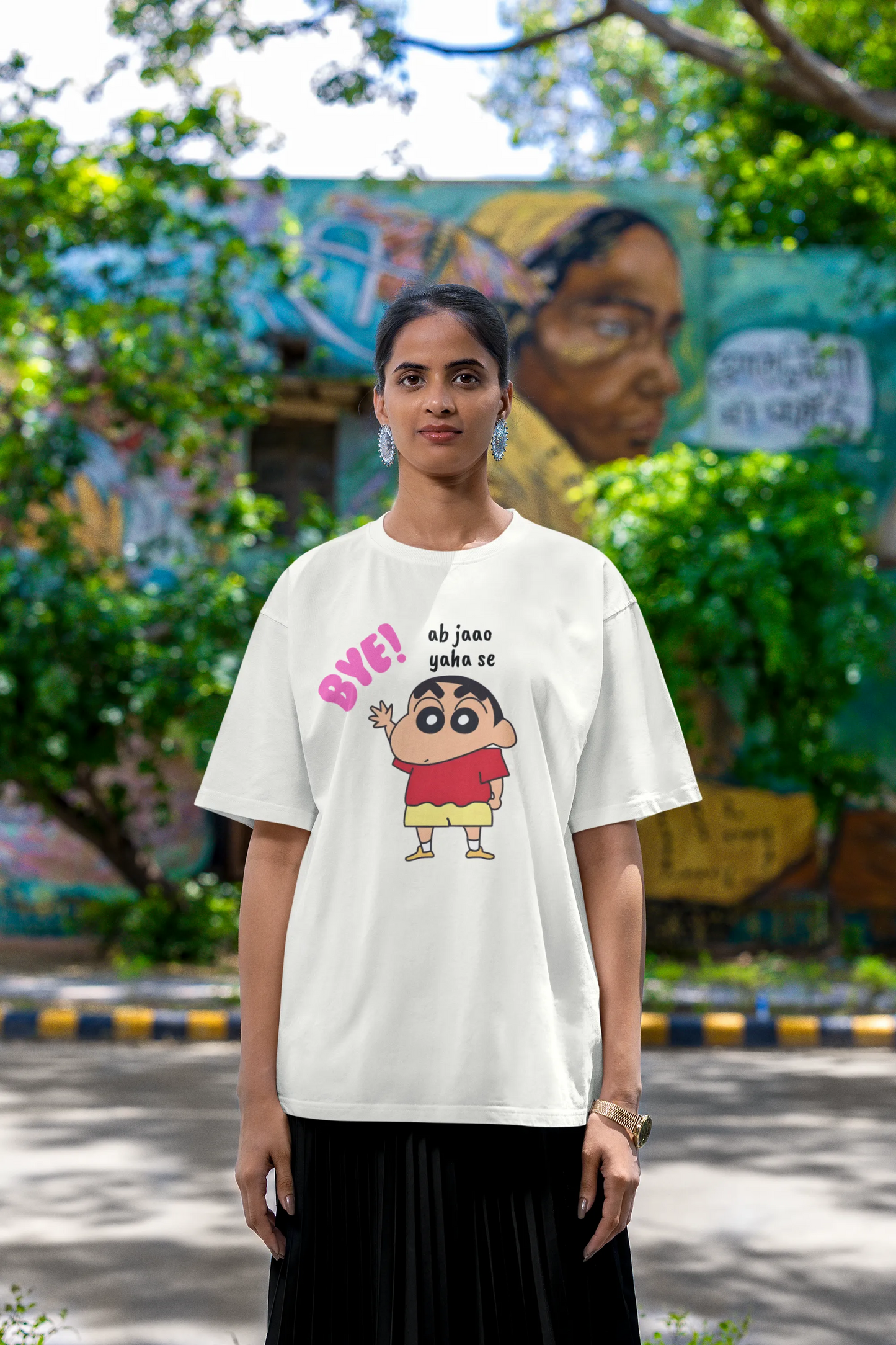 Fourth front view of an female model wearing an off-white oversized tee featuring Shinchan saying "Ab Jhao" in Hindi. A perfect blend of humor and nostalgia for Shinchan fans.