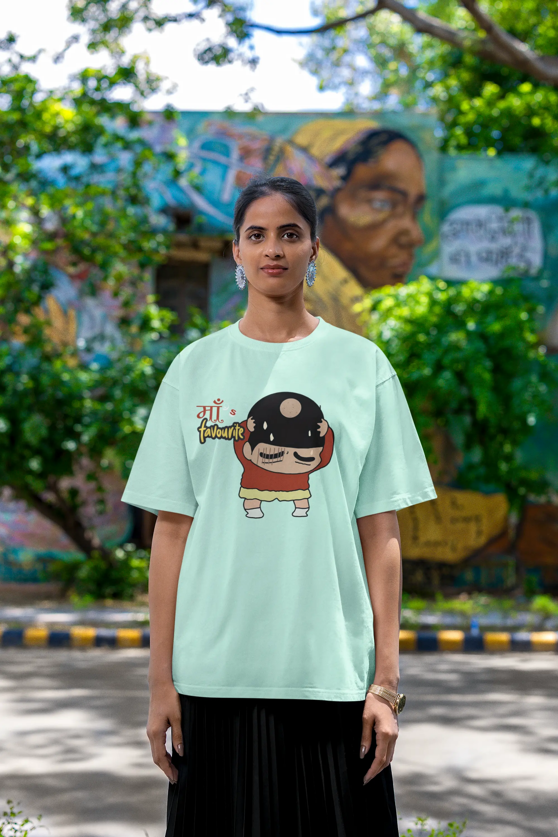 First front view of female model wearing a mint green oversized tee featuring Shinchan with a classic bump on his head. A perfect blend of humor and nostalgia for Shinchan fans.