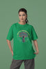 Second front view of a female model wearing a forest green oversized t-shirt featuring a psychedelic magic mushroom with an aura, perfect for a hippie, trance, or groovy style.