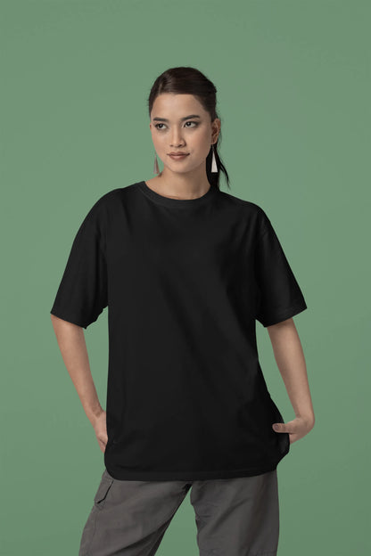 Front view of a female model wearing a black oversized t-shirt with a metal flower design and "Be a Voice, Not an Echo" slogan.