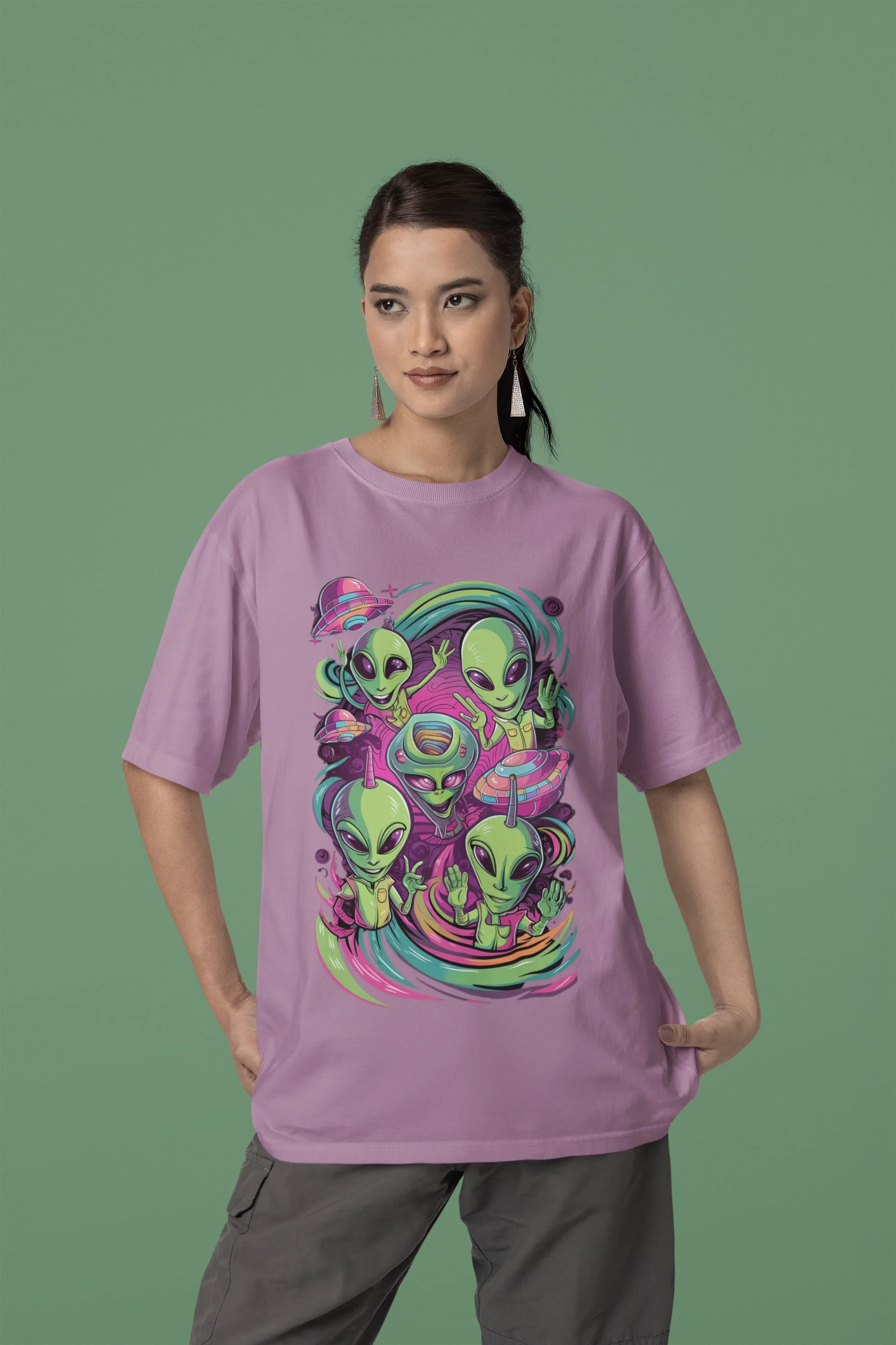 First front view of a female model wearing a dirty purple oversized t-shirt with a psychedelic design featuring green aliens and spaceships, perfect for a hippie, trance, or groovy style.