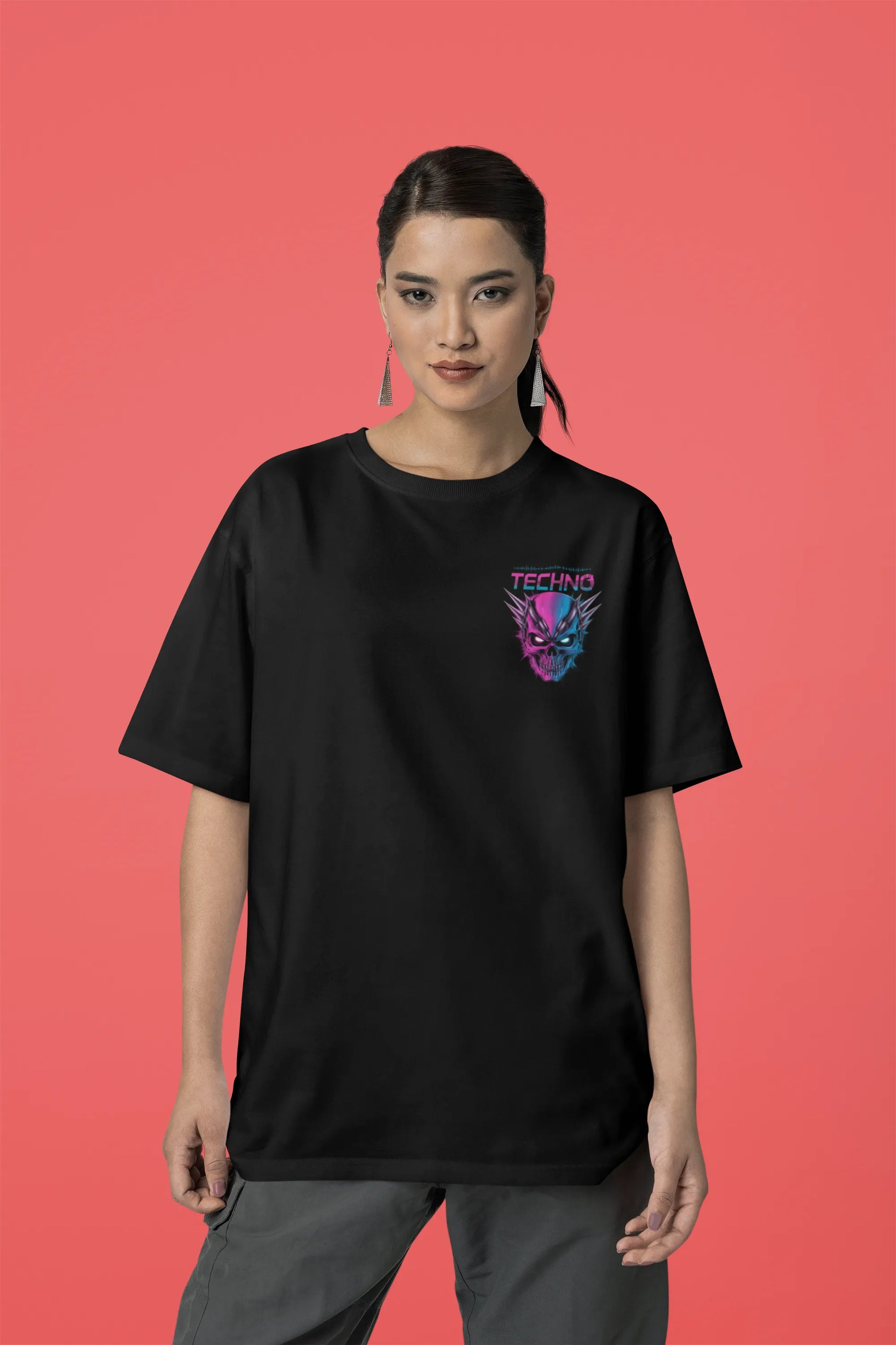 Third front view of a female model wearing an black oversized t-shirt with a stylized Techno Skull design, perfect for rave and party vibes.