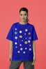 Front view of female model wearing a royal blue oversized t-shirt featuring a vibrant floral design with roses, tulips, sunflowers, and orchids. Ideal for those who love floral patterns and spring fashion. 