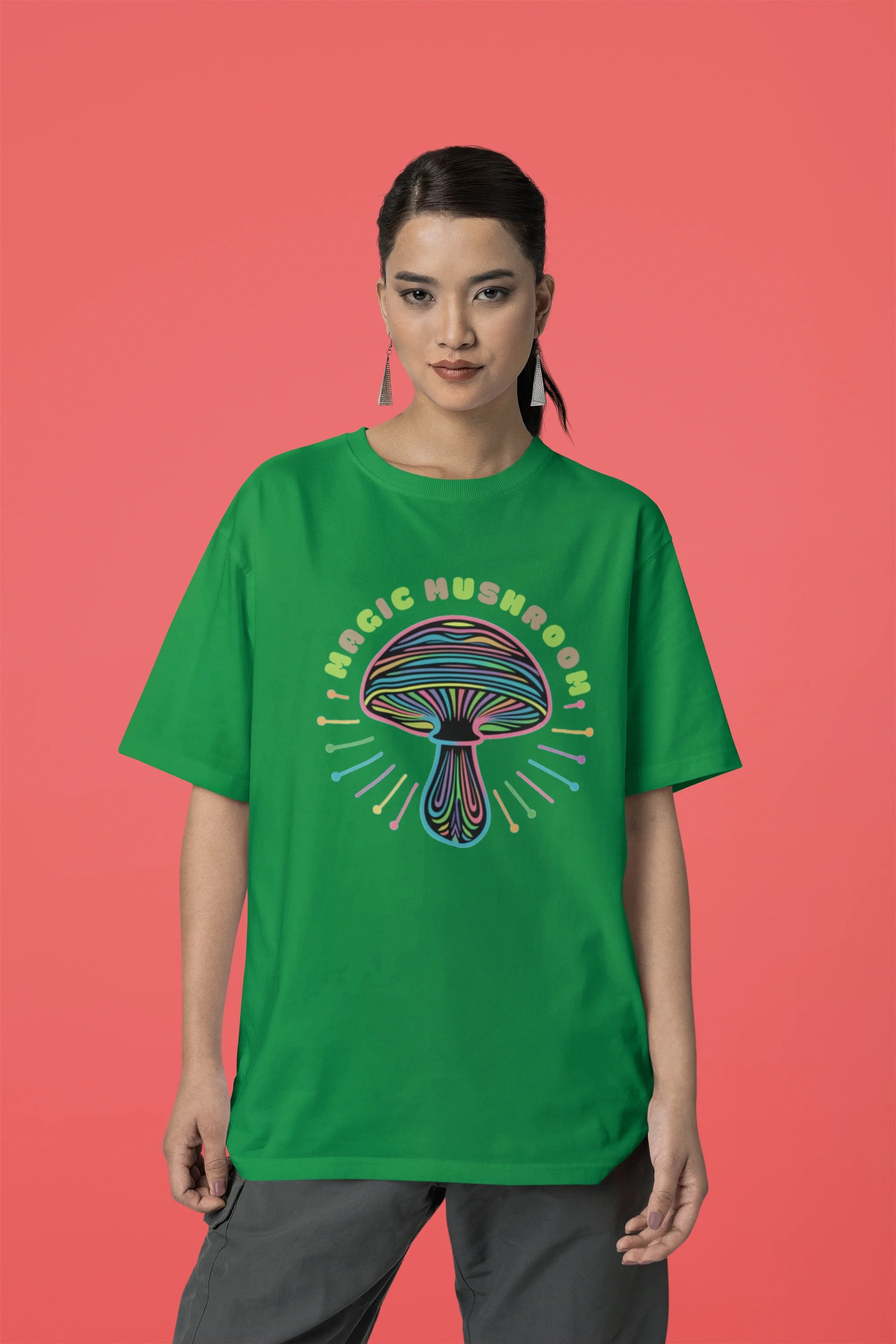 First front view of a female model wearing a forest green oversized t-shirt featuring a psychedelic magic mushroom with an aura, perfect for a hippie, trance, or groovy style.