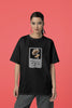 Third front view of a female model wearing a black oversized t-shirt featuring a design inspired by Alessia Cara's song 