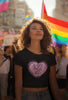 Third front view of a female model wearing a black crop top with a heart-shaped 