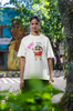 First front view of an female model wearing an off-white oversized tee featuring Shinchan saying 