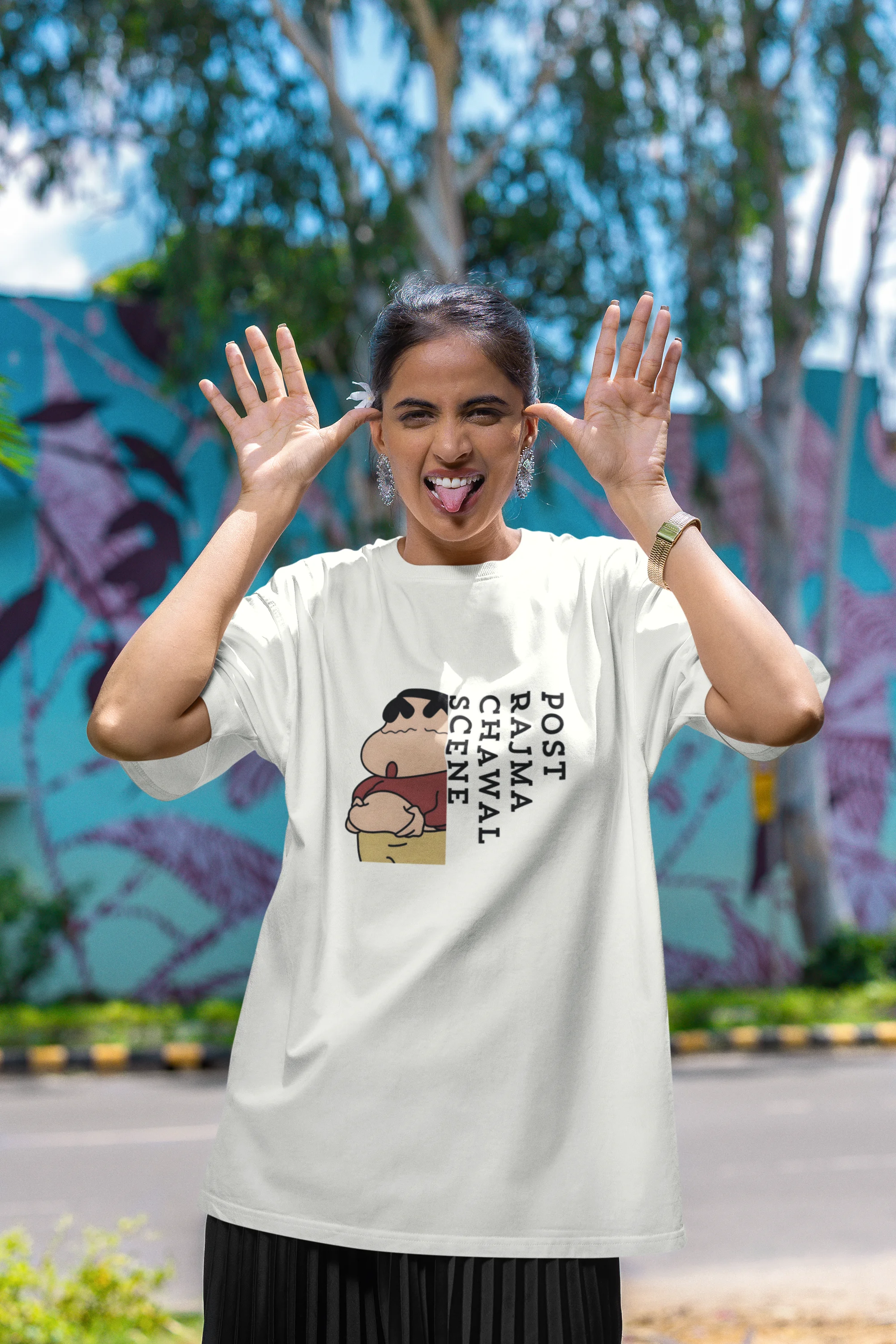 First front image of female model wearing an oversized off-white tee with a humorous design of Shinchan enjoying a food coma. A must-have for Shinchan fans and food lovers.