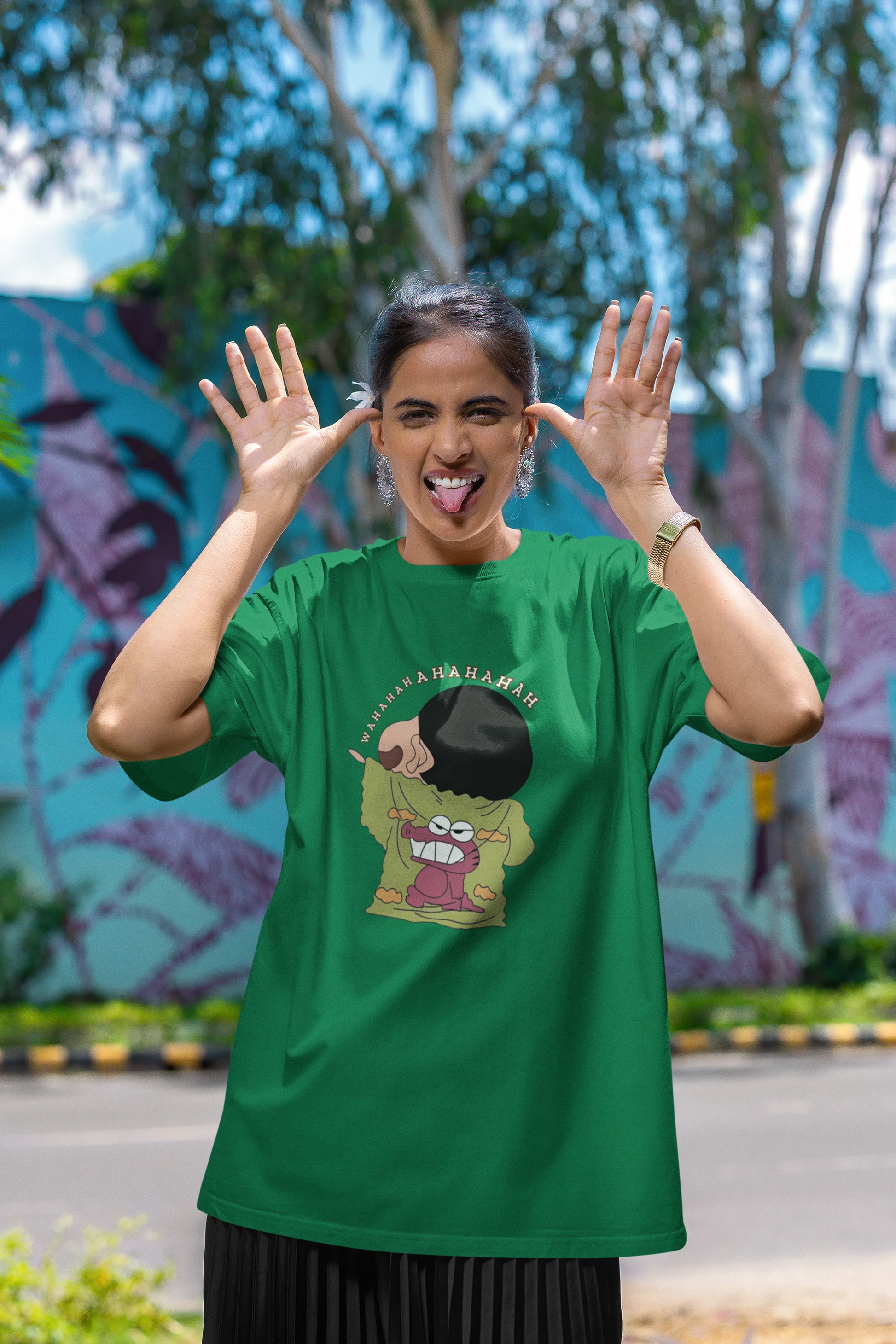 First front view of female model wearing a forest green oversized t-shirt with a design of Shinchan laughing hysterically. Perfect for Shinchan fans who love the character's humor.