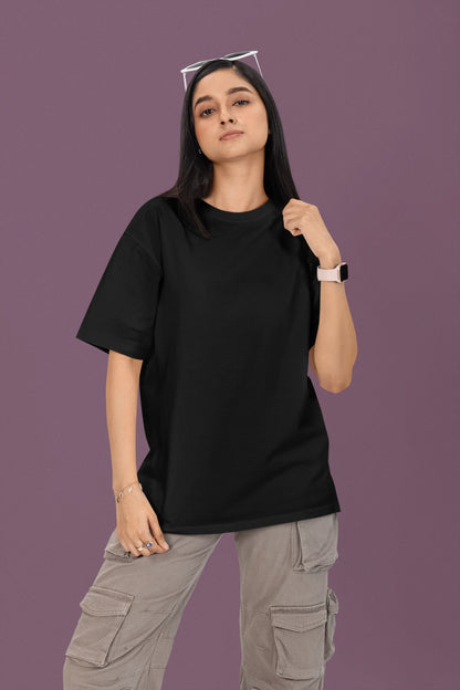 2nd front view of a female model wearing a black oversized t-shirt featuring a couple dancing in the moonlight, inspired by Ed Sheeran's themes of love.