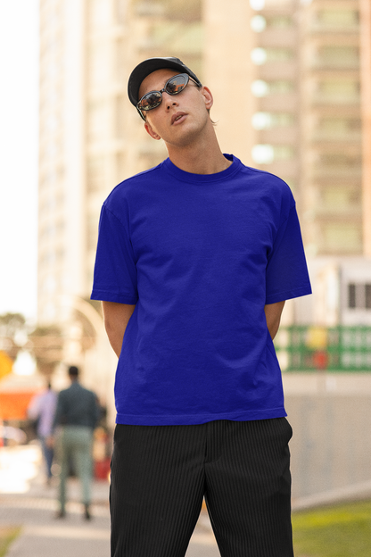 2nd front view of a male model wearing a royal blue oversized t-shirt featuring Crocodile, the Desiccation Master, from the One Piece anime.